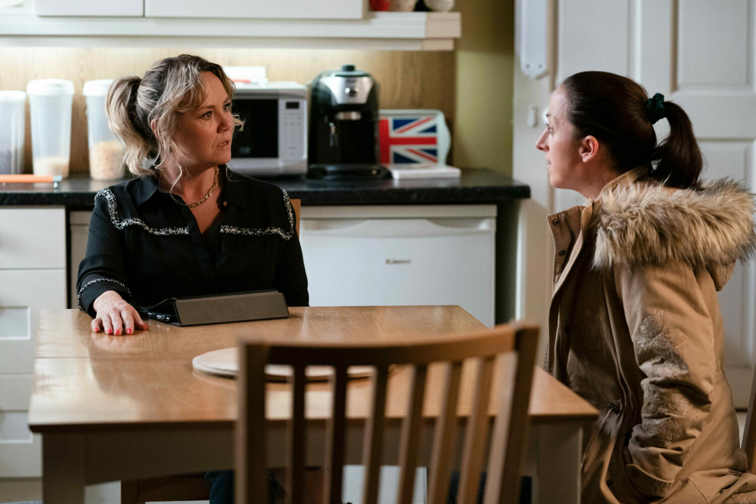Janine Butcher looks shocked as Sonia Fowler gives her news in the kitchen of The Vic