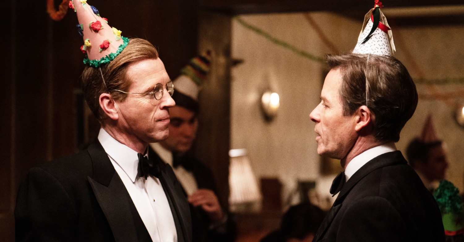 Damian Lewis and Guy Pearce at a party in A Spy Among Friends
