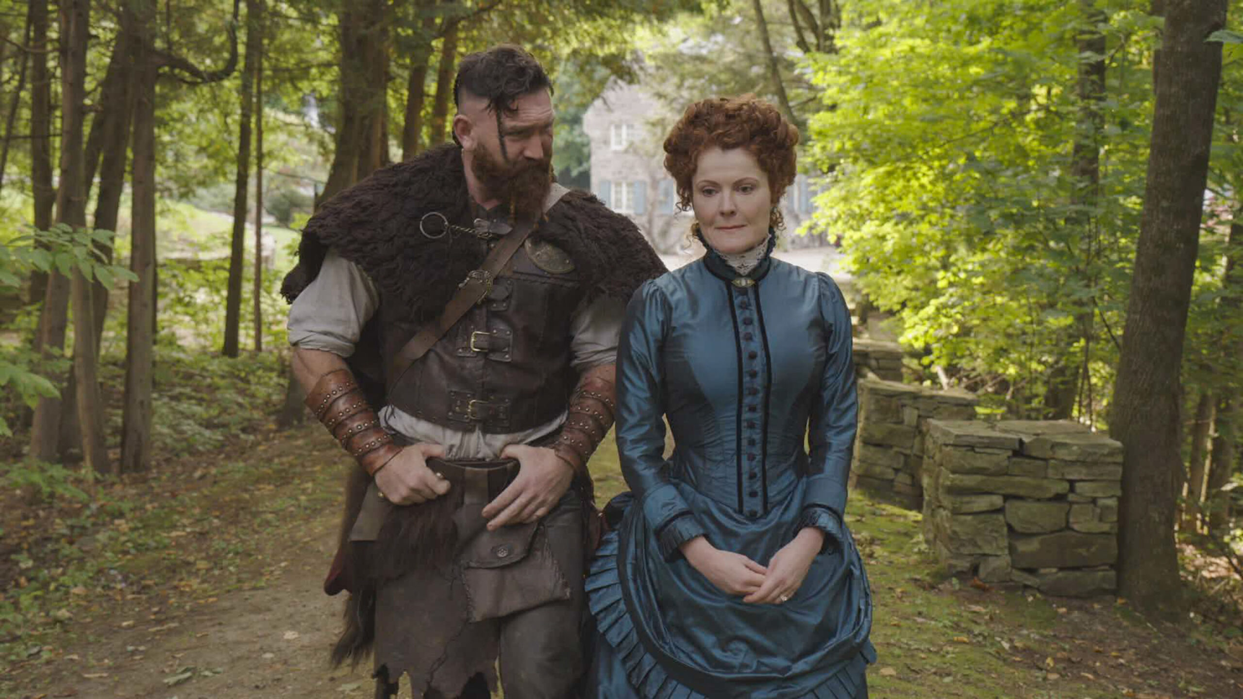 Hetty and Thorfinn walk on the grounds of Woodstone Estate in Ghosts US