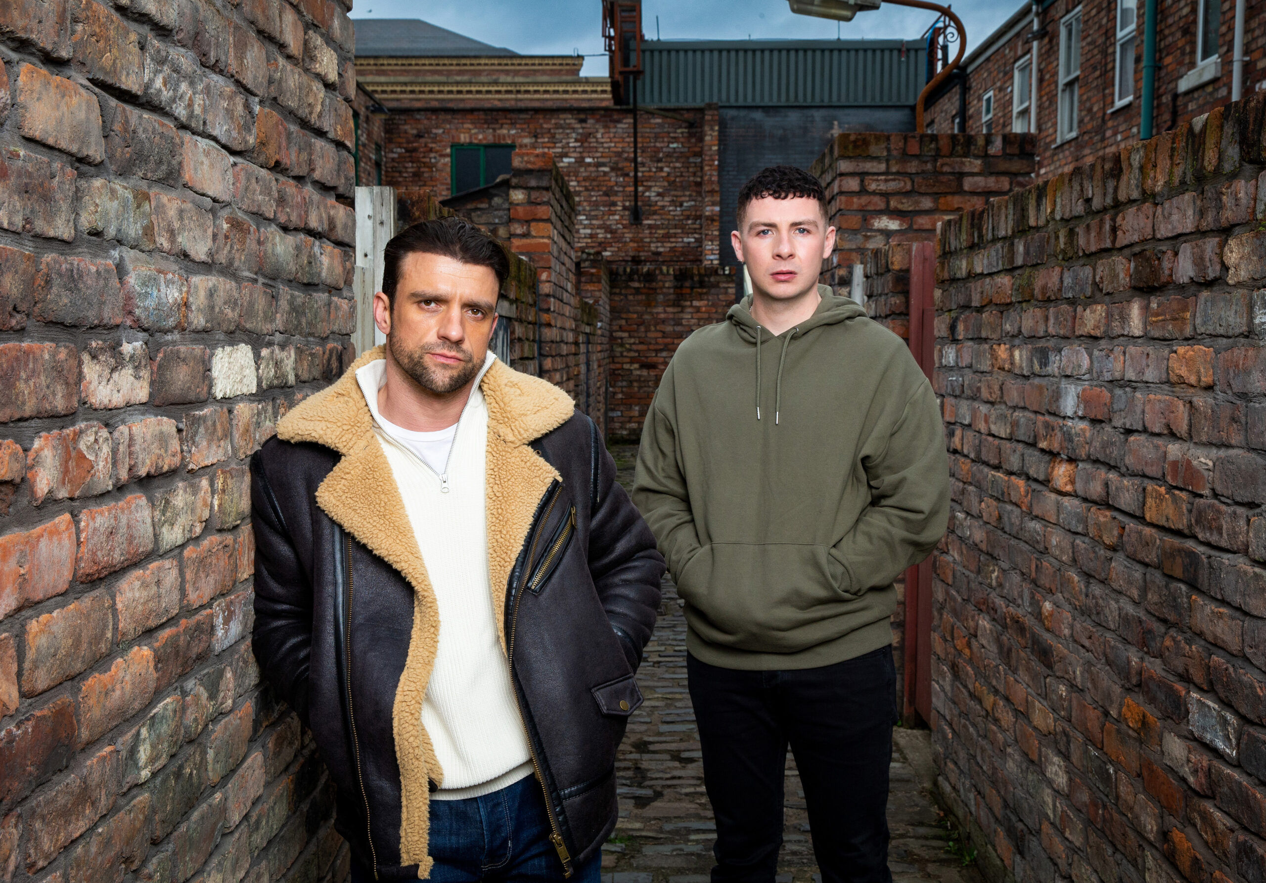 Jacob and father Damon stand side-by-side in the alleys - Damon looks menacing on Coronation Street