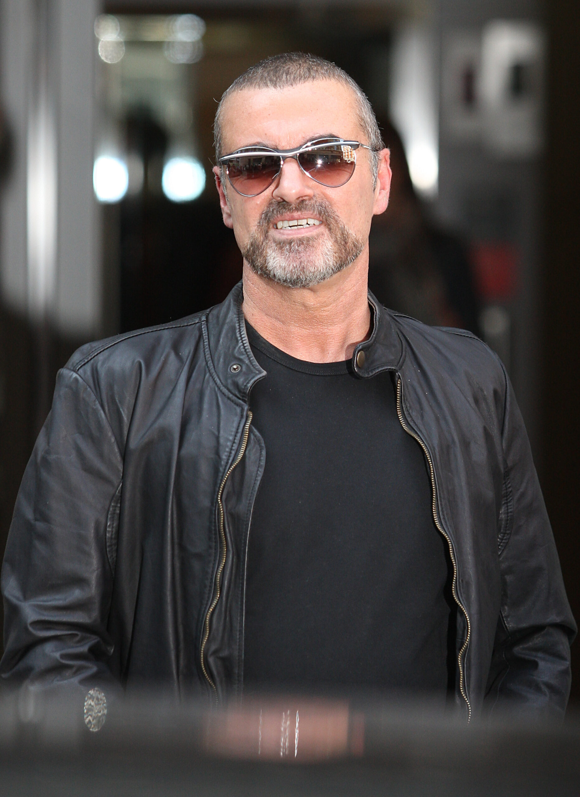 George Michael smiling in sunglasses