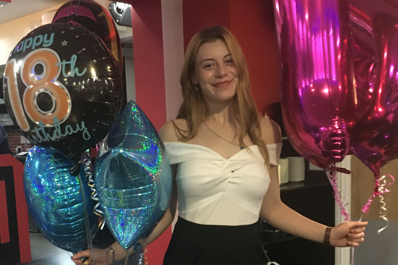 Megan Newton holding balloons in What the Killer Did Next