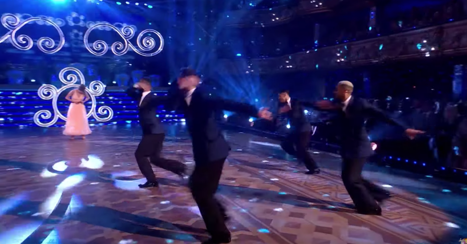 Ellie being strapped into a harness on Strictly Blackpool special