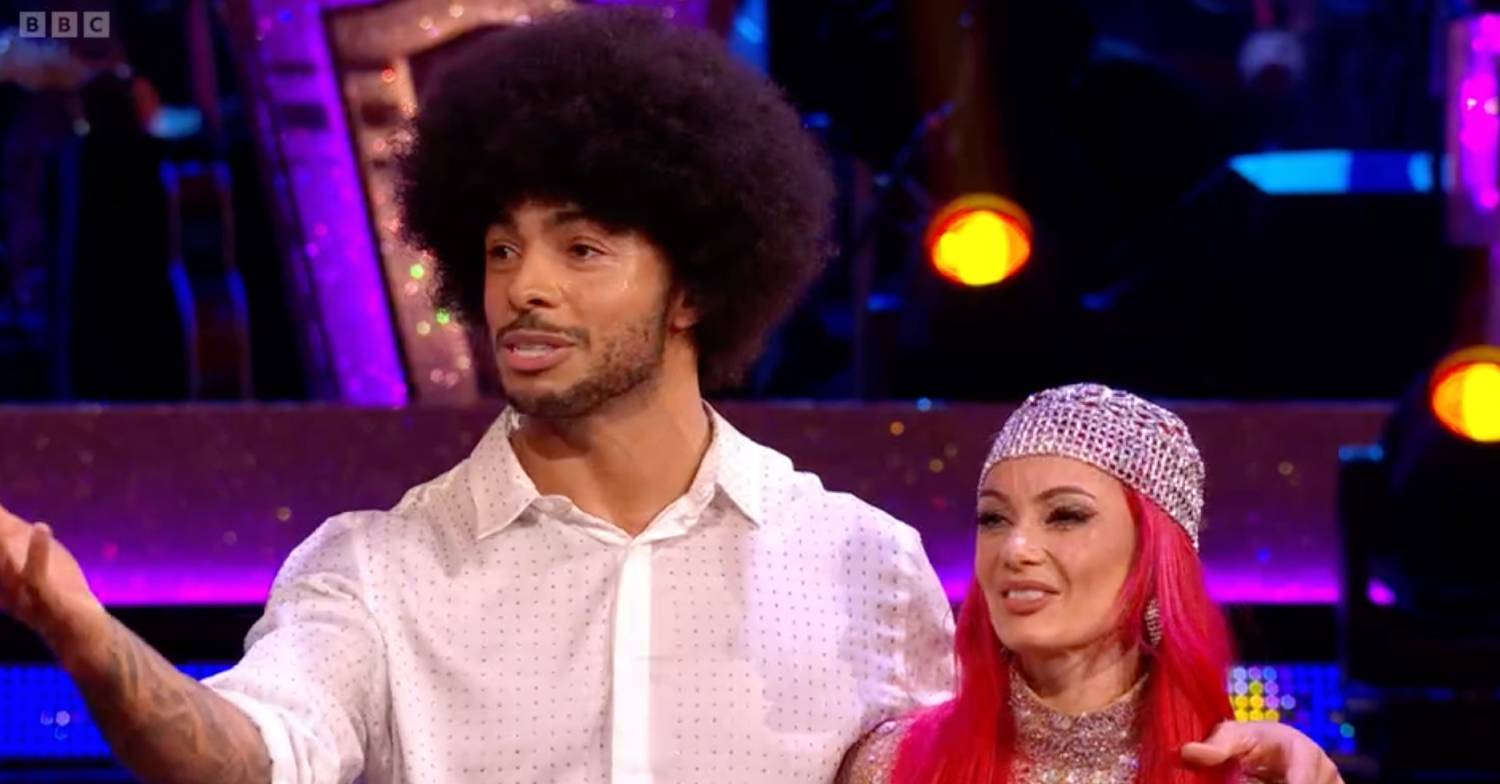 Strictly contestant Tyler West stands with Dianne Buswell