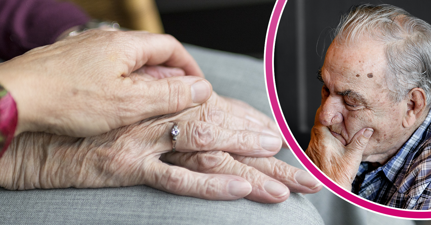 Elderly woman holding hands and elderly man looking worried