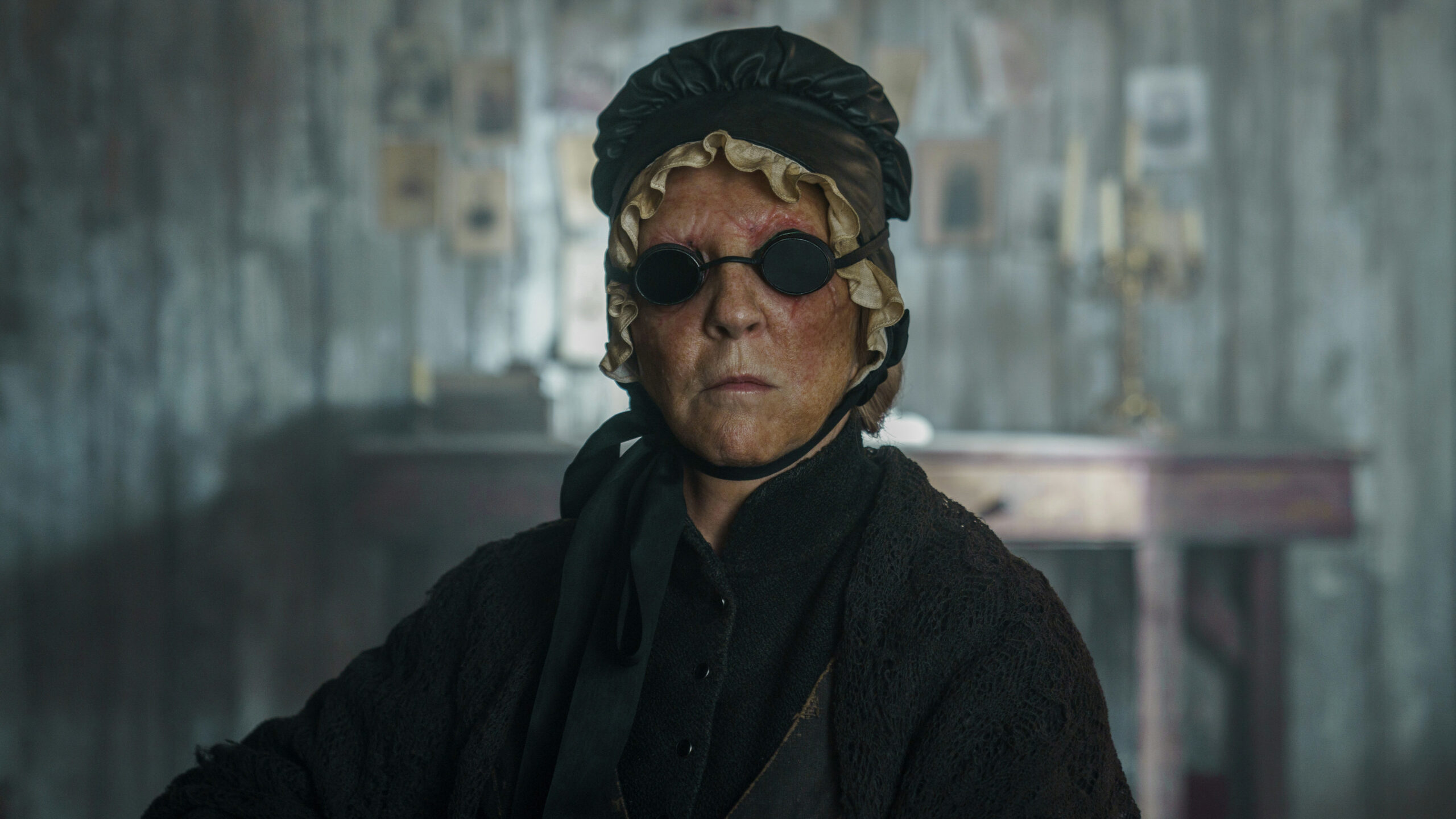 Black Eyed Mog frowns with her black glasses on in The English