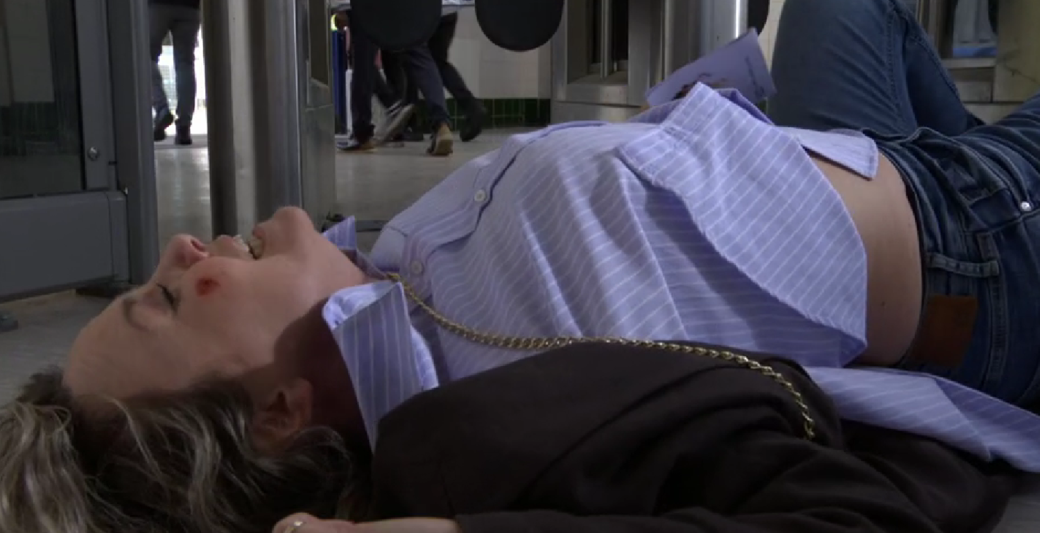 Janine lying on the floor in pain in EastEnders