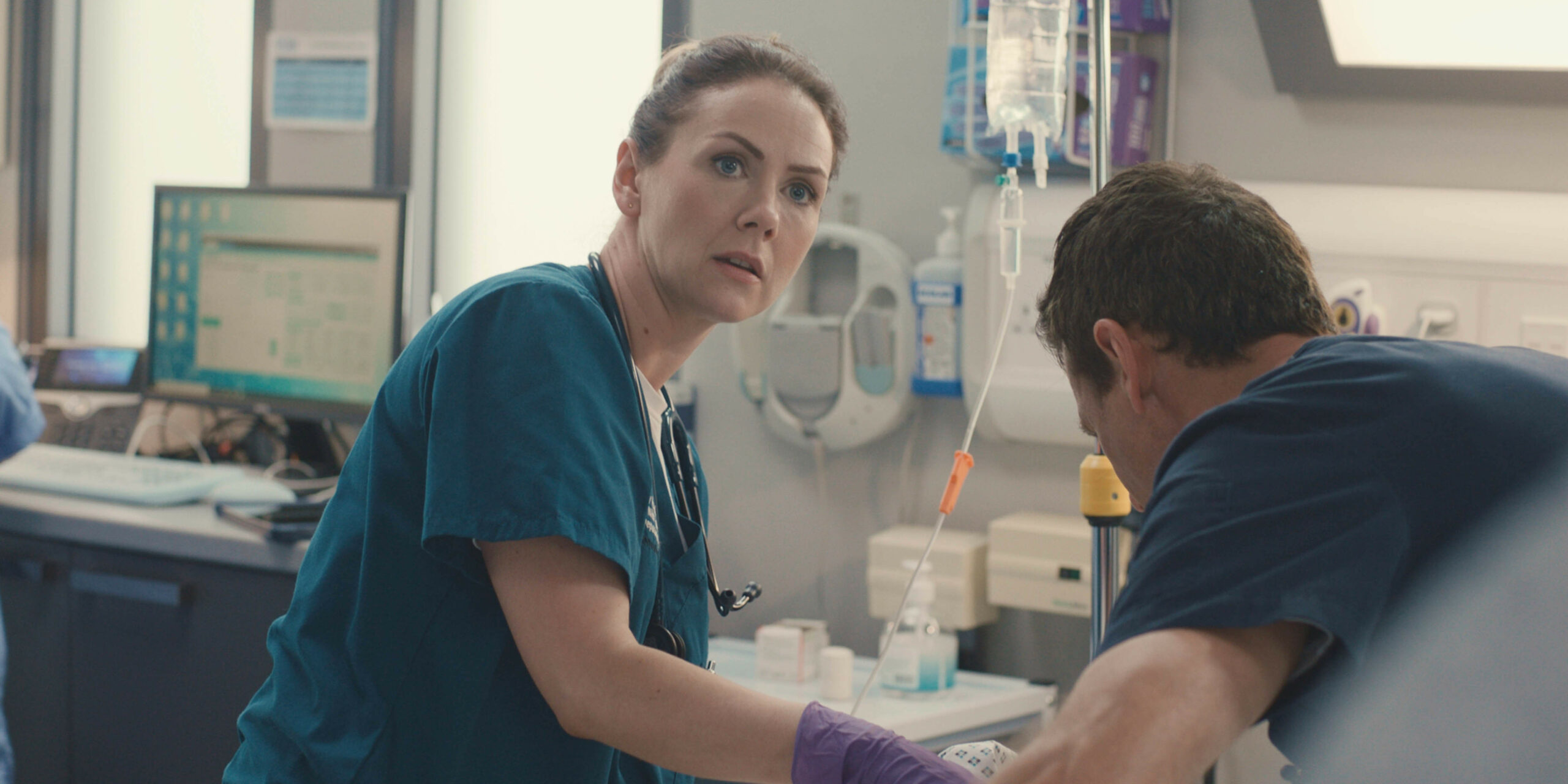 Stevie Nash looking worried as she treats a patient