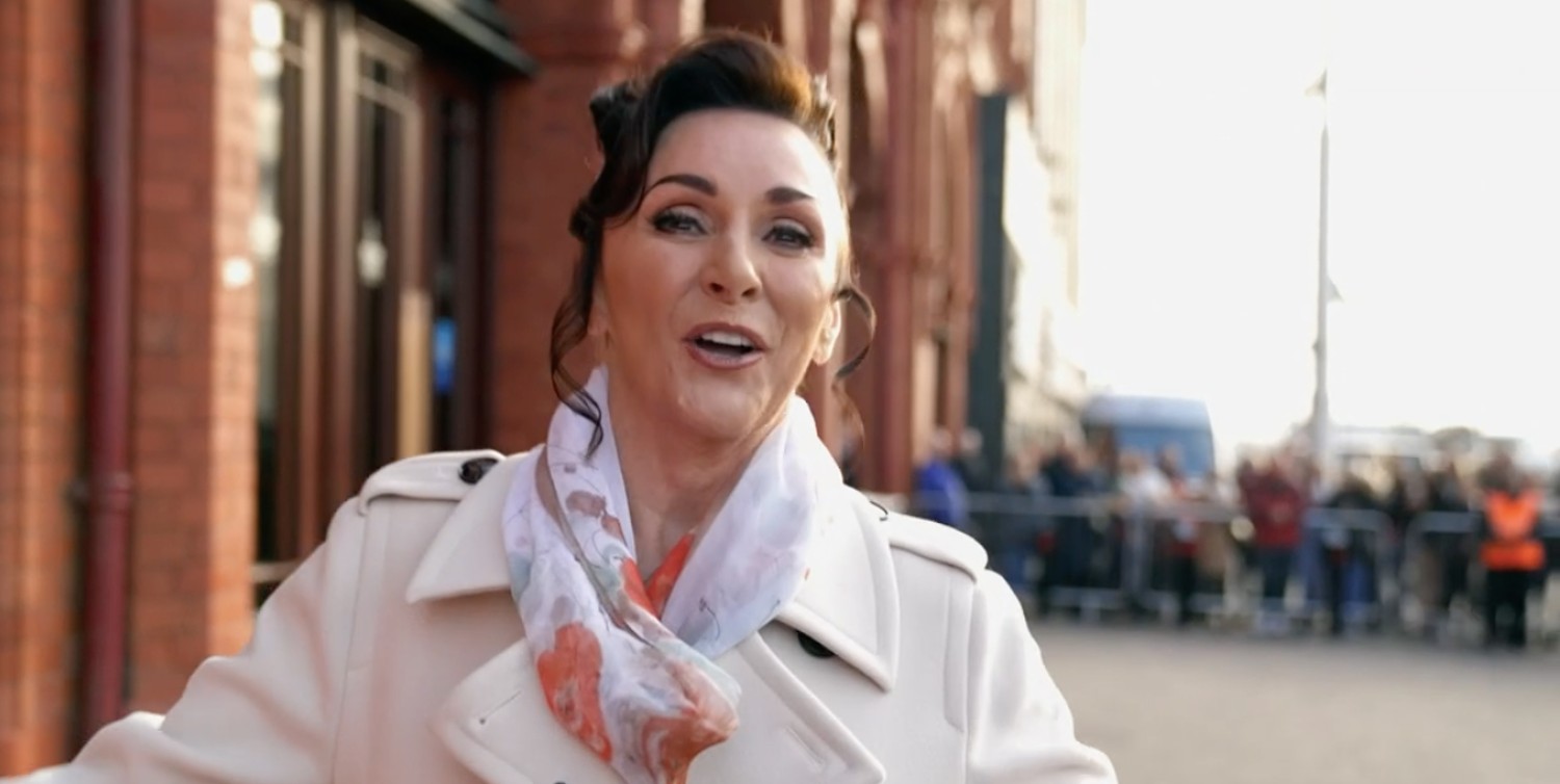 Shirley Ballas smiling in a beige coat