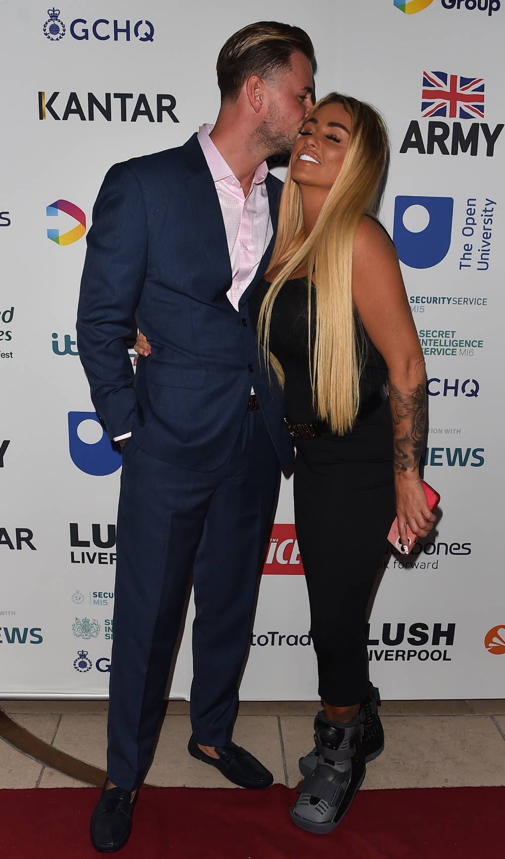 Katie Price receives a kiss from Carl Woods