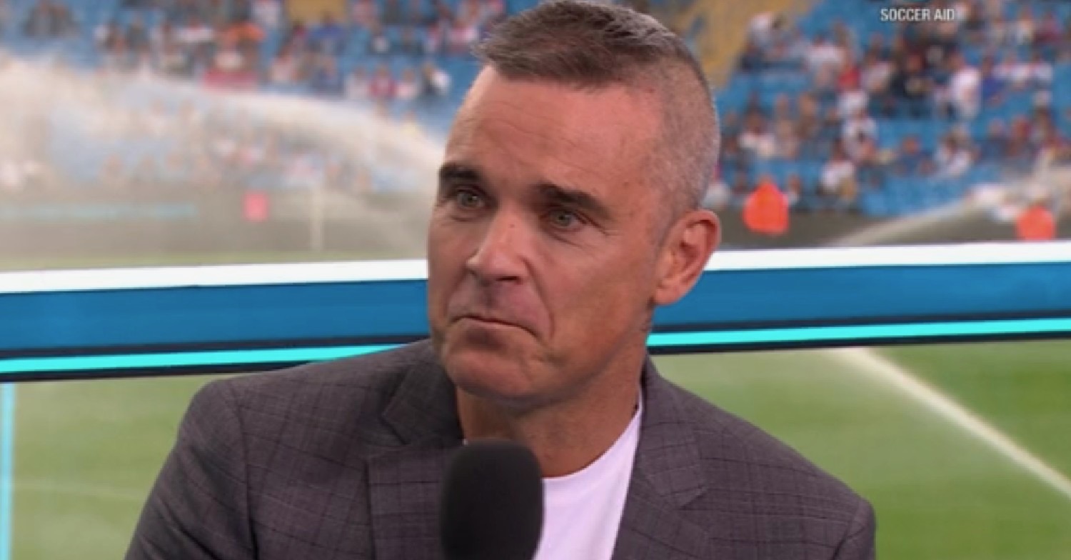Robbie Williams being interviewed at the football