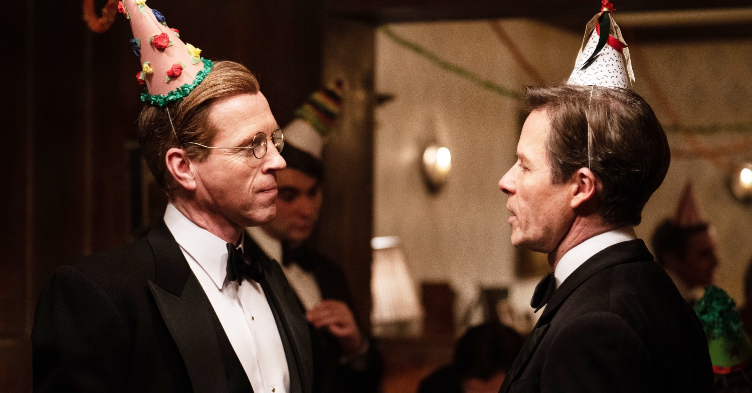 Damian Lewis and Guy Pearce as Nick Elliott and Kim Philby at a party
