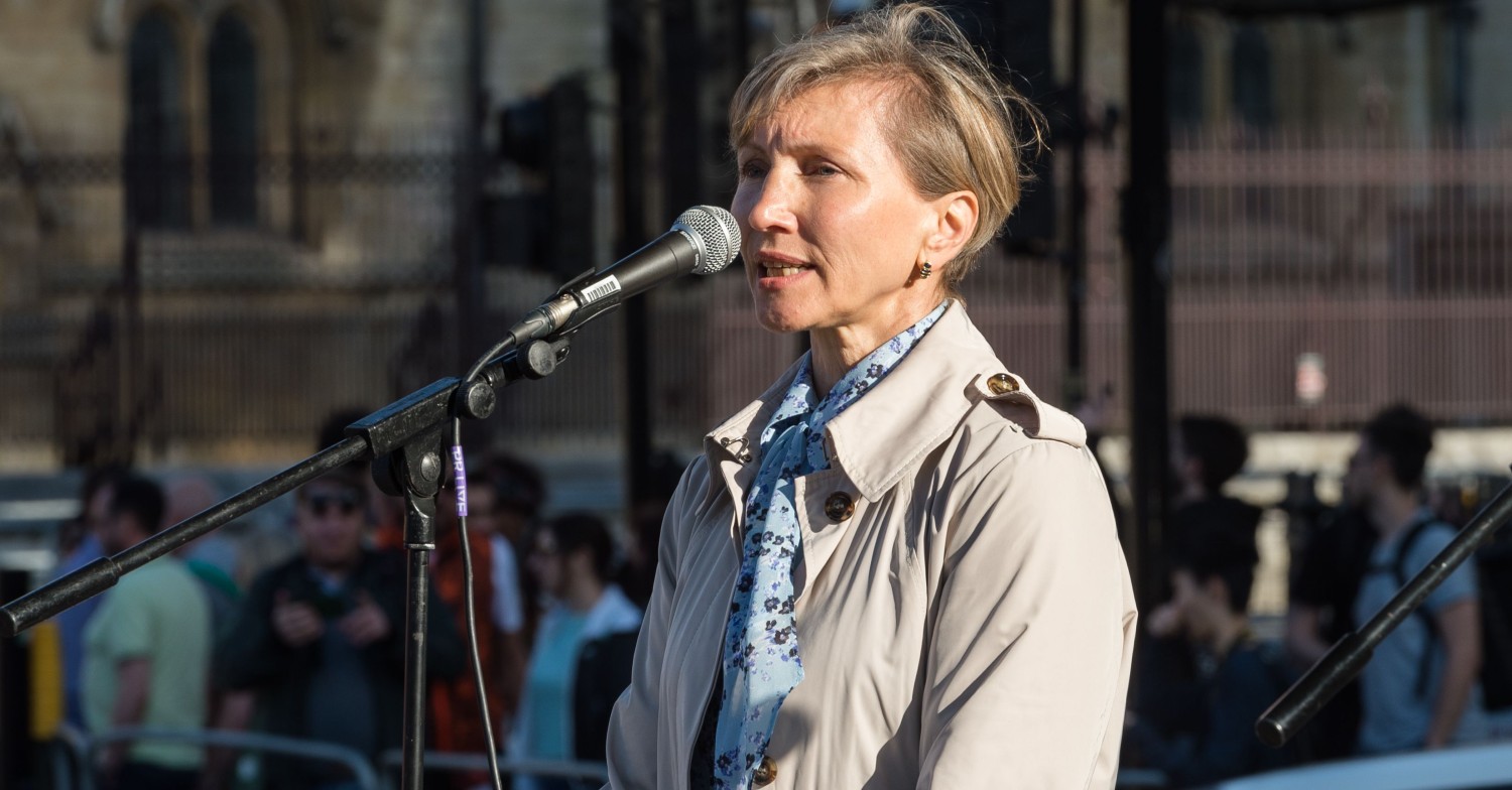 Marina Litvinenko, wife of poisoned Alexander standing in front of a microphone