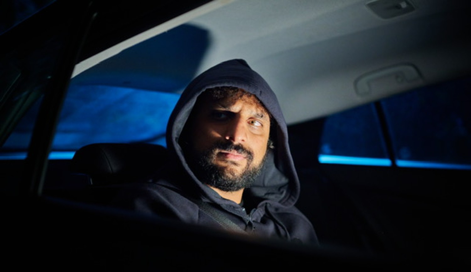 Nish Kumar wearing a hood in Christmas Carole