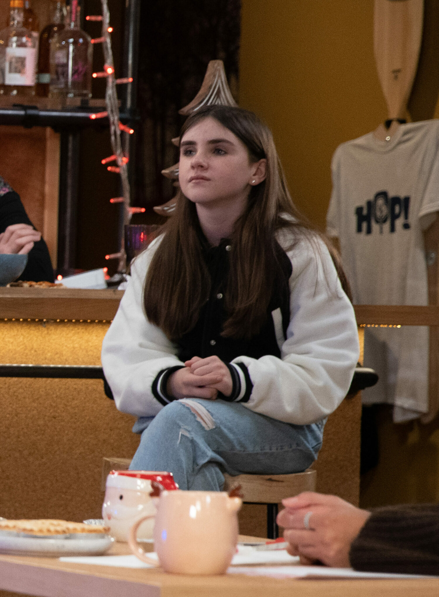 April is sitting whilst looking rebellious in Emmerdale