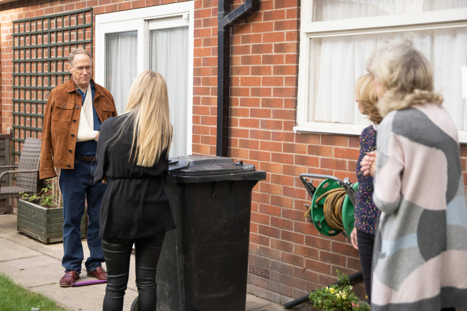 Stephen looks worried at Sarah, Gail and Audrey in Corrie