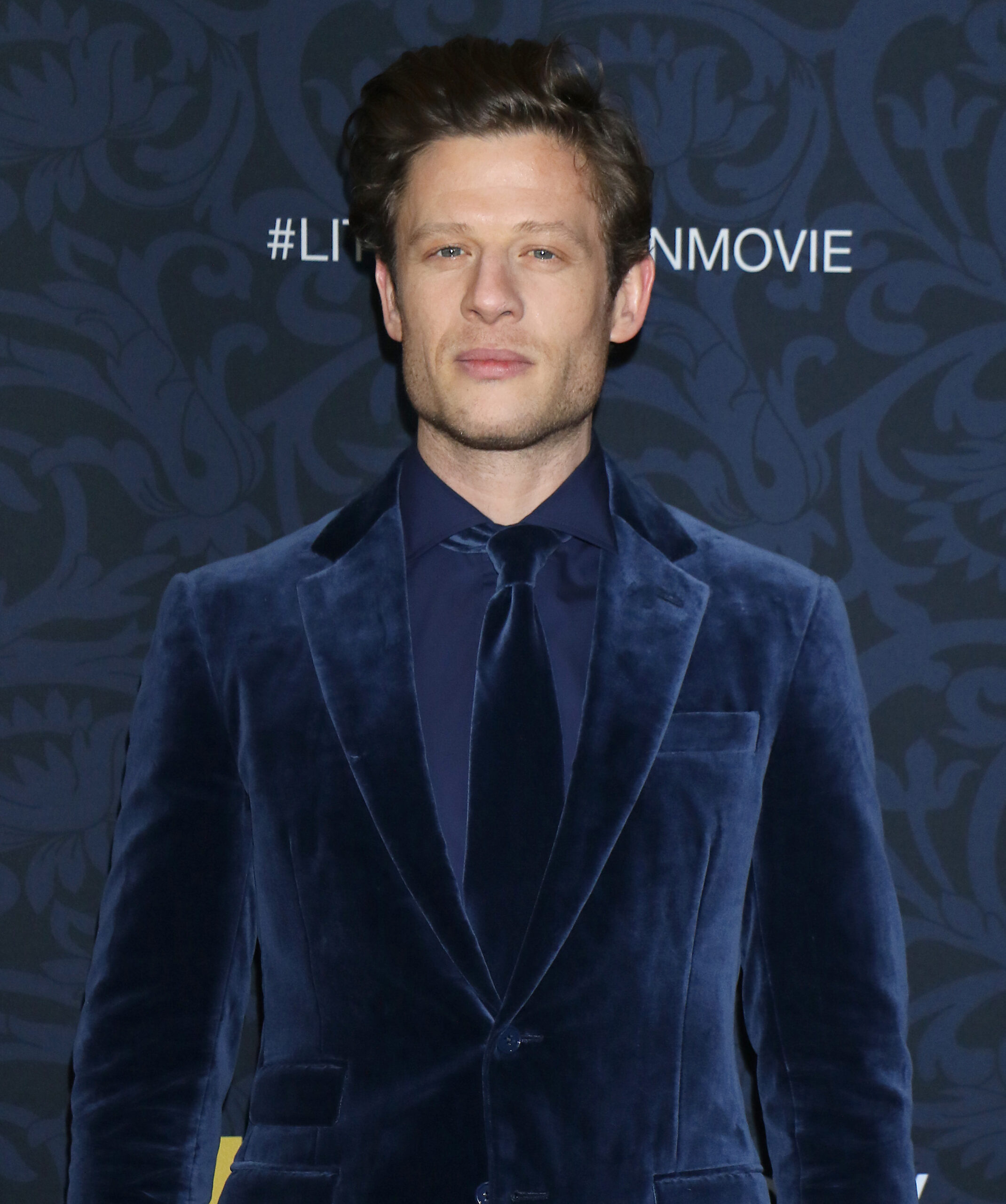 James Norton wearing a blue suit on the red carpet