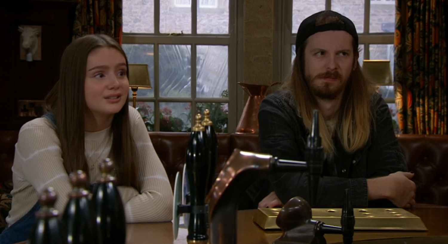 Sarah and Ryan sat at the Woolpack bar in Emmerdale 