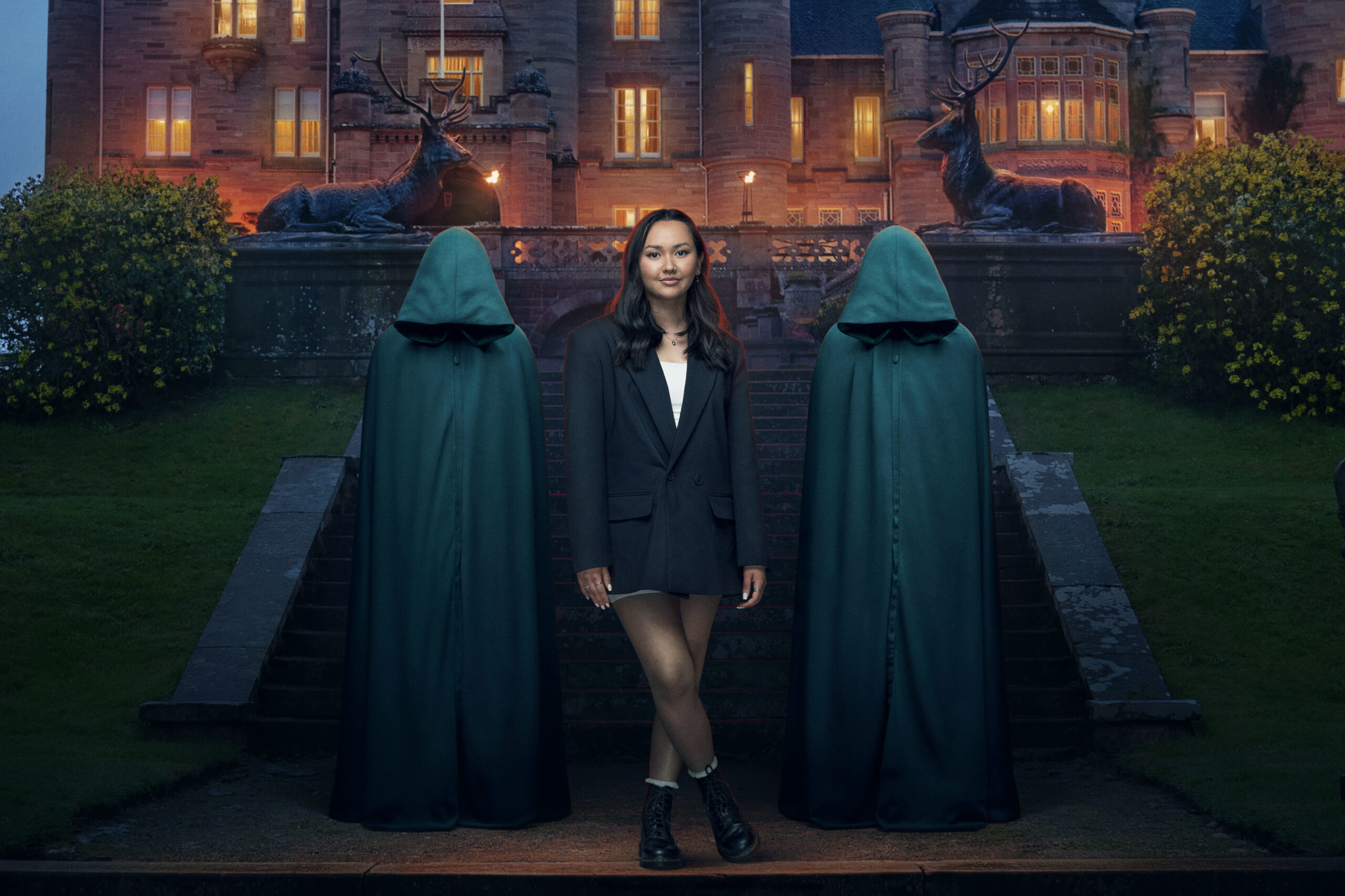 Alyssa smiles between the two hoods on The Traitors