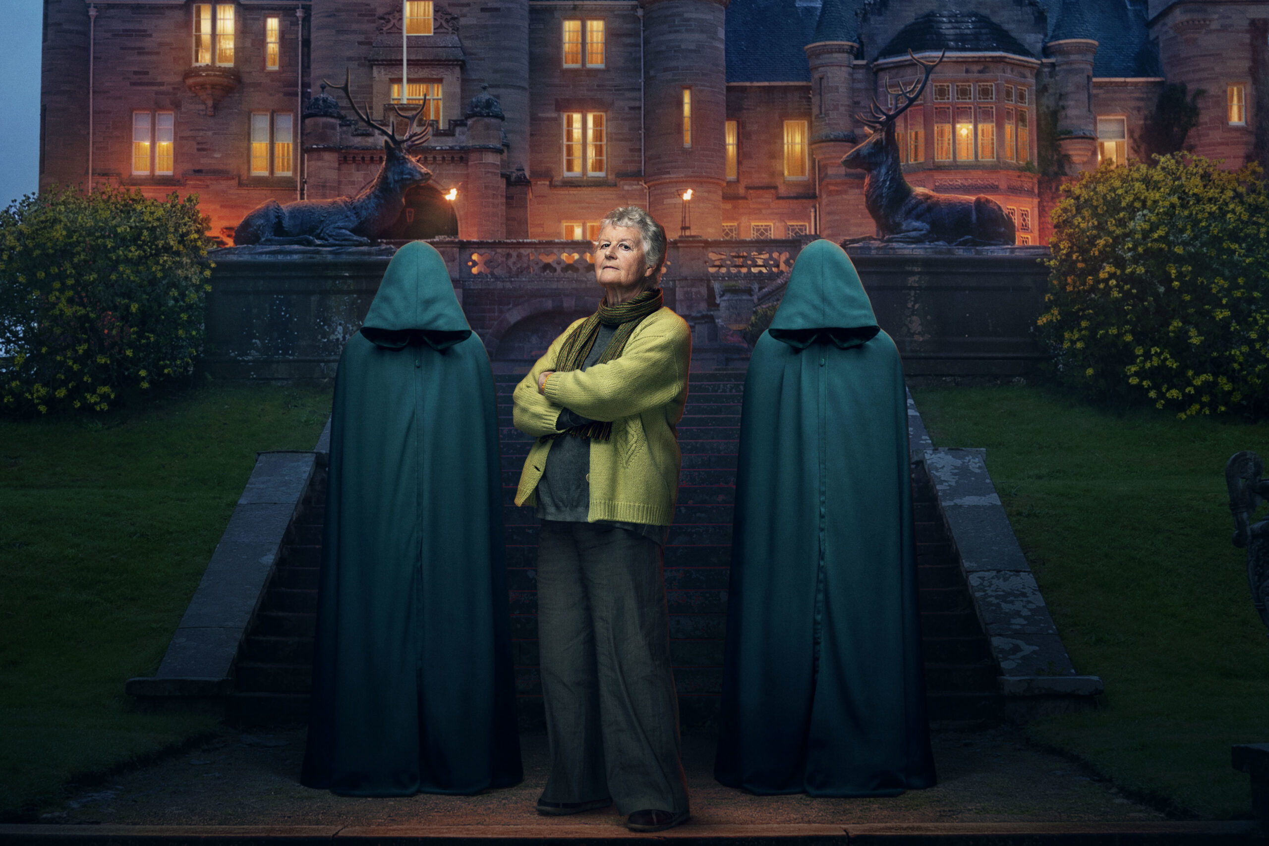 Contestant Andrea poses between the two hoods in The Traitors