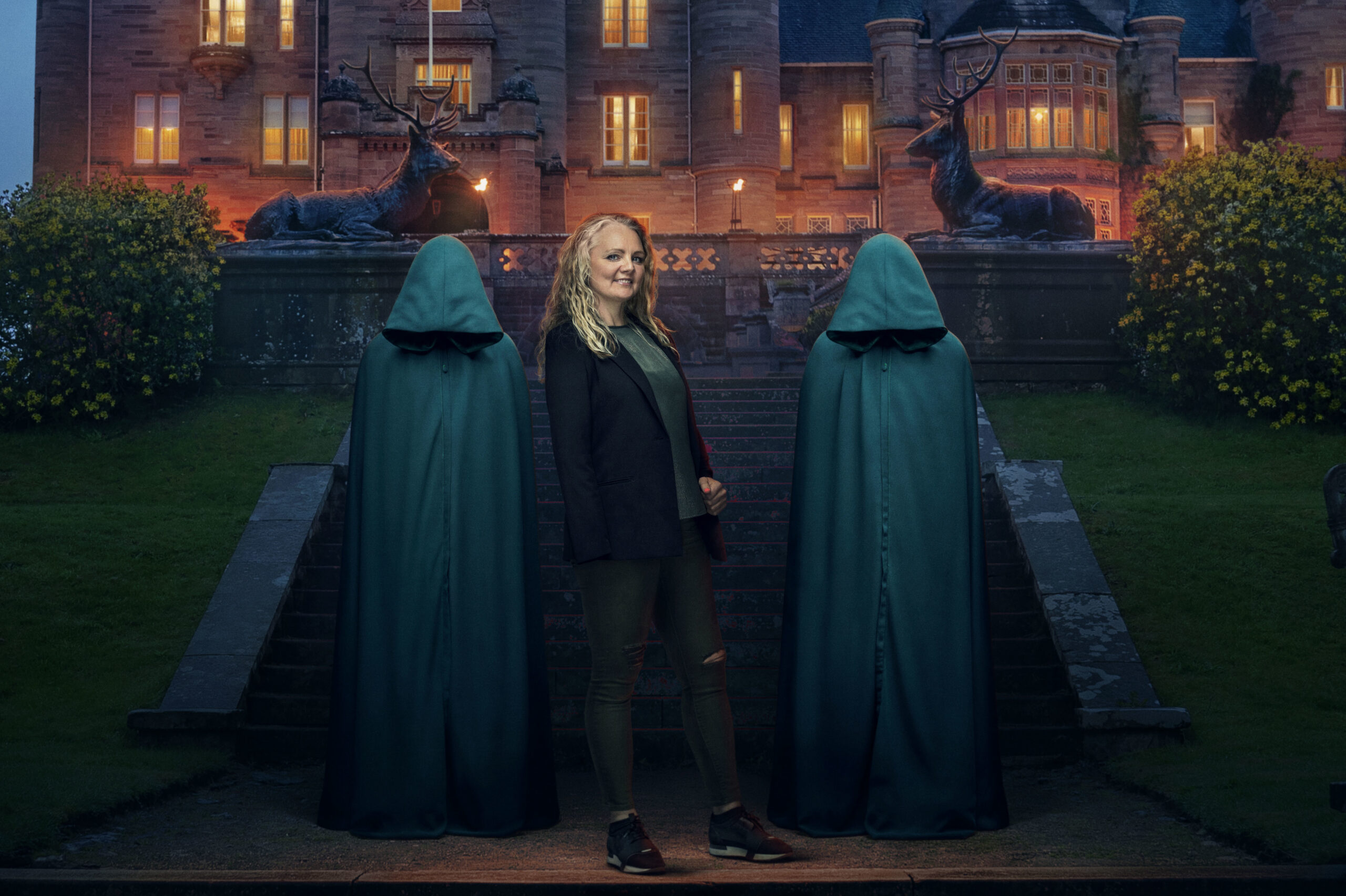 Contestant Nicky stands between The Traitors