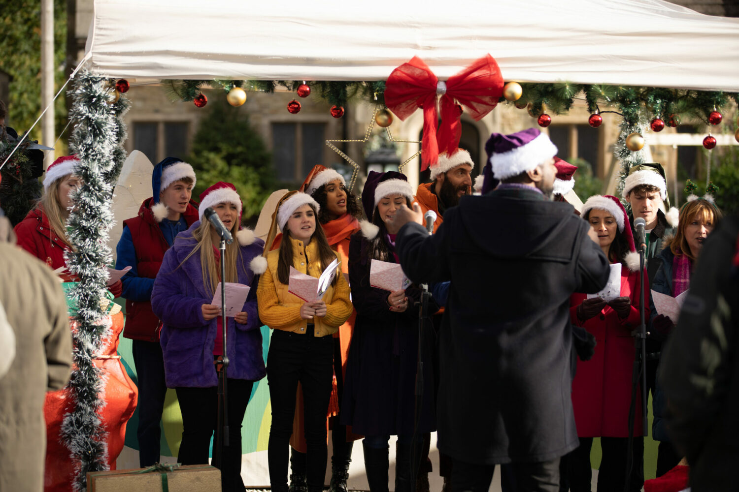 Emmerdale's Cathy is singing in the choir with April, whilst wearing a Santa hat