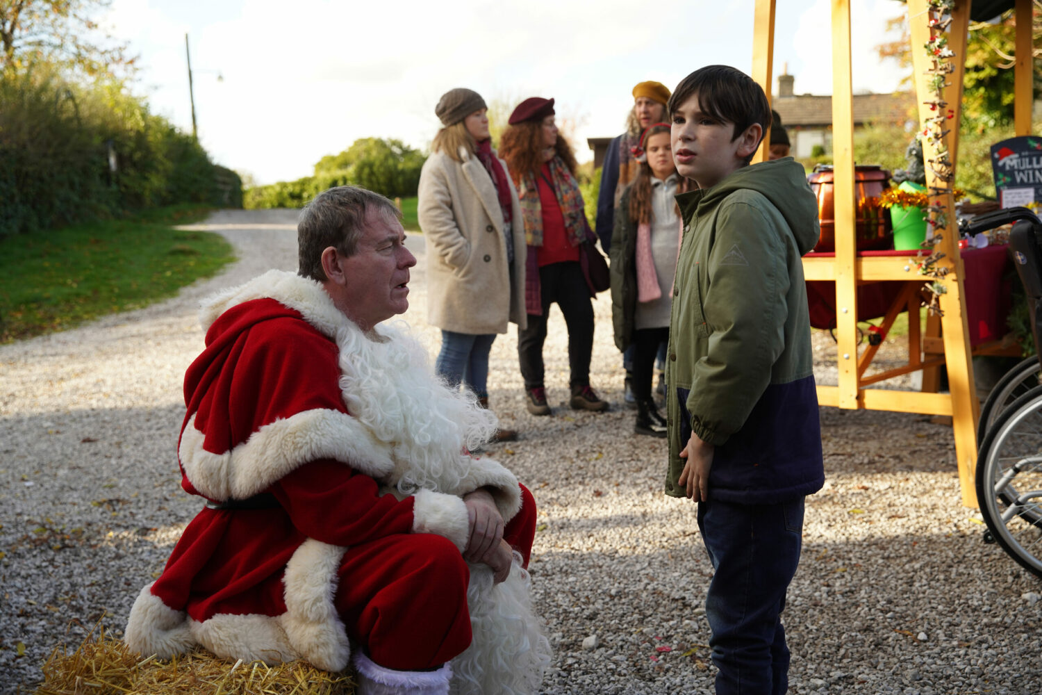 While talking to PC Swirling, who is dressed as Santa, Kyle looks off-camera, on Emmerdale