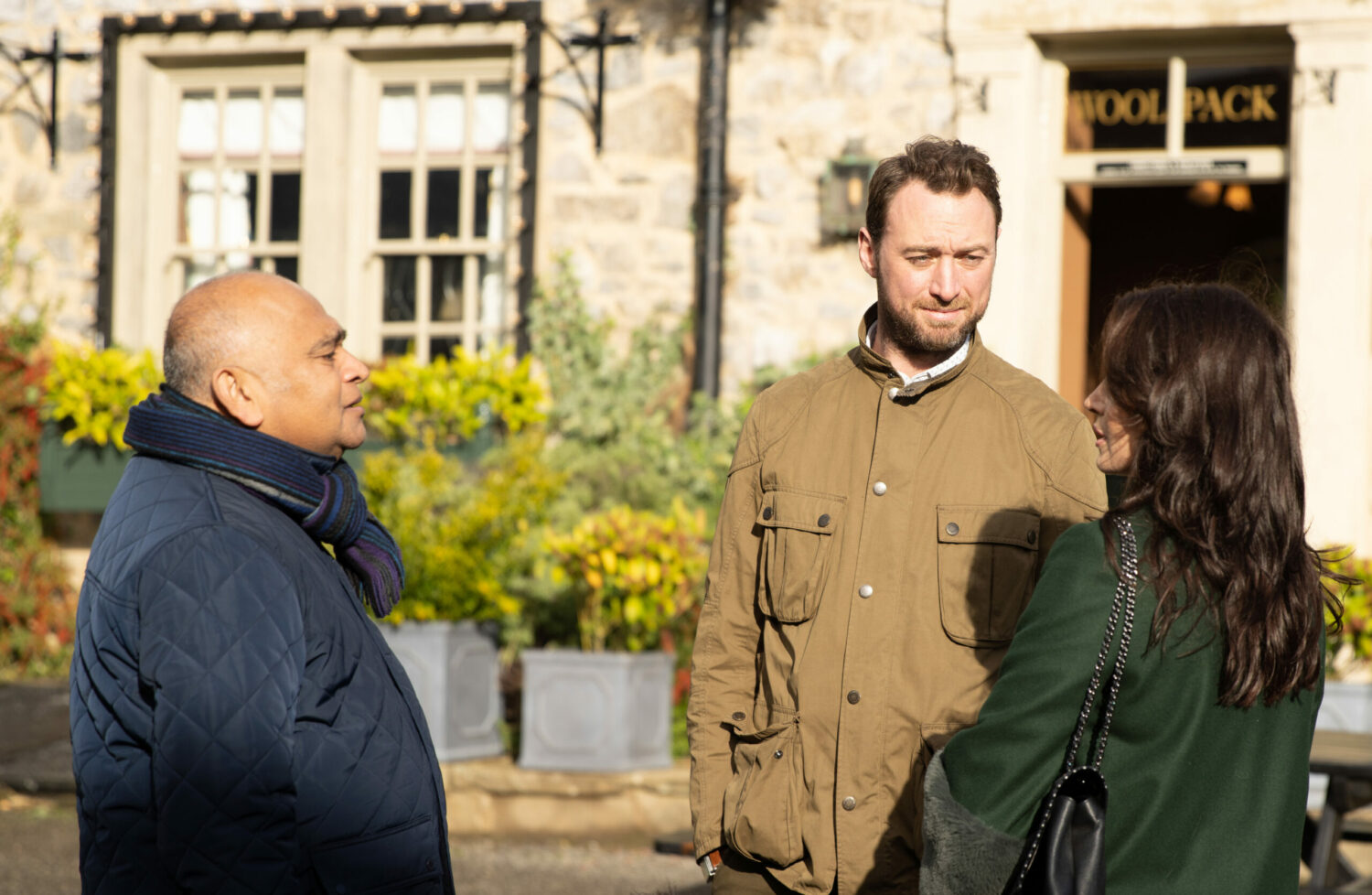 Rishi, Liam and Leyla all talk outside the Woolpack in Emmerdale