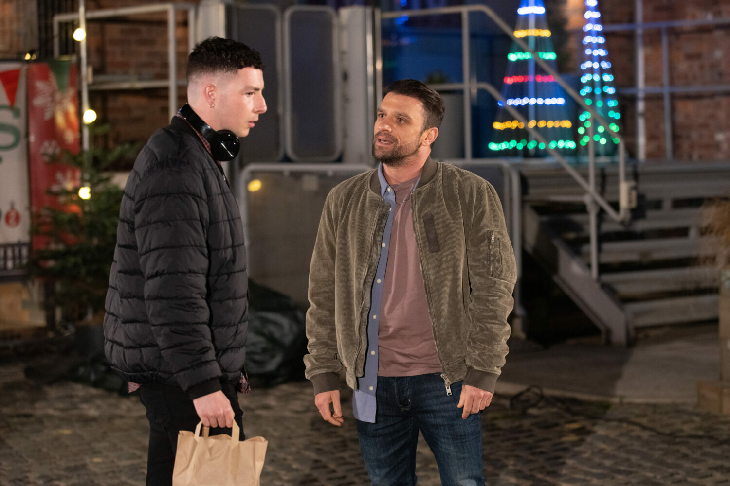 Jacob looks unhappy as Damon talks to him on Coronation Street