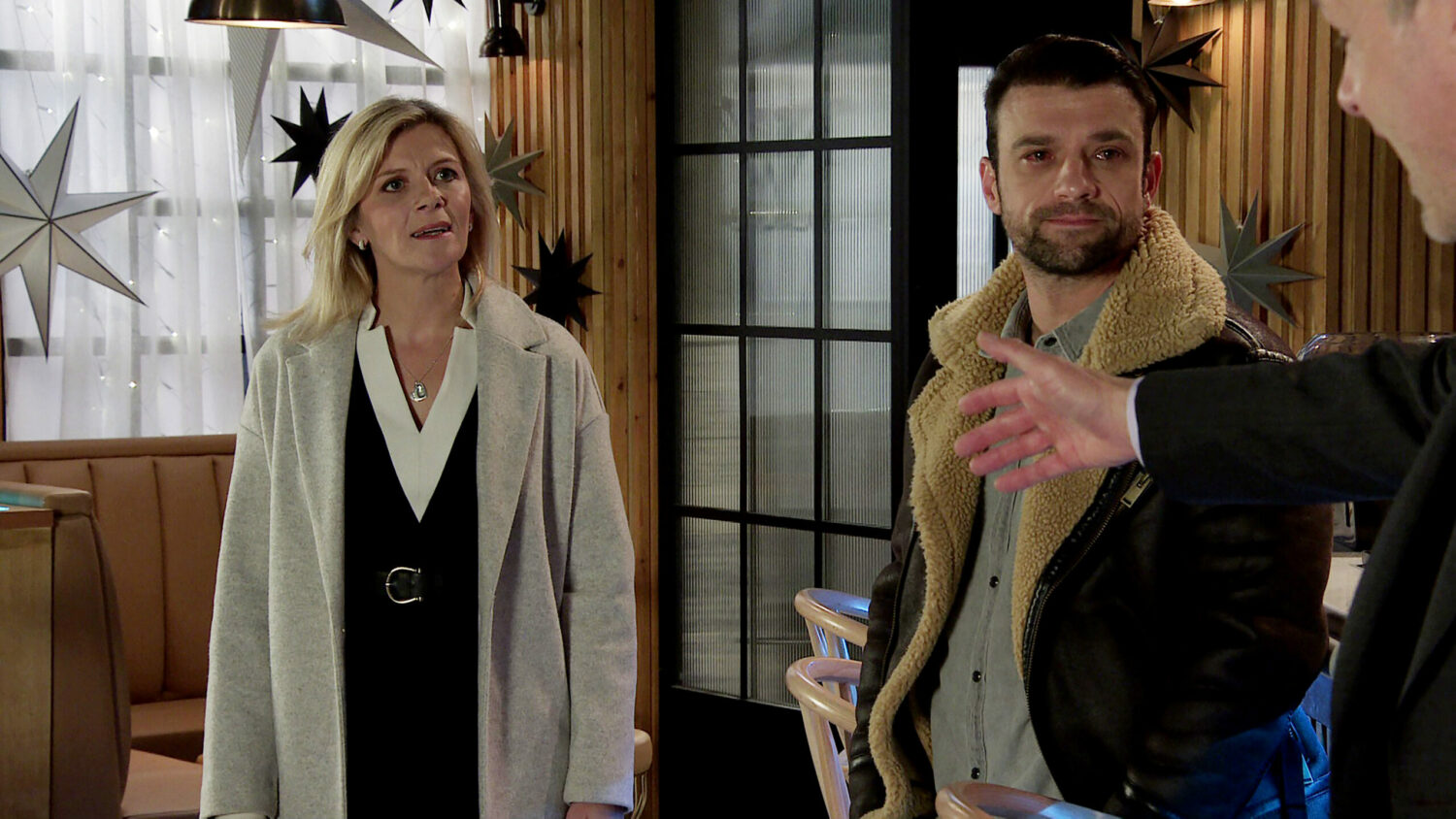 Leanne looks unhappy while Damon talks to Nick on Corrie