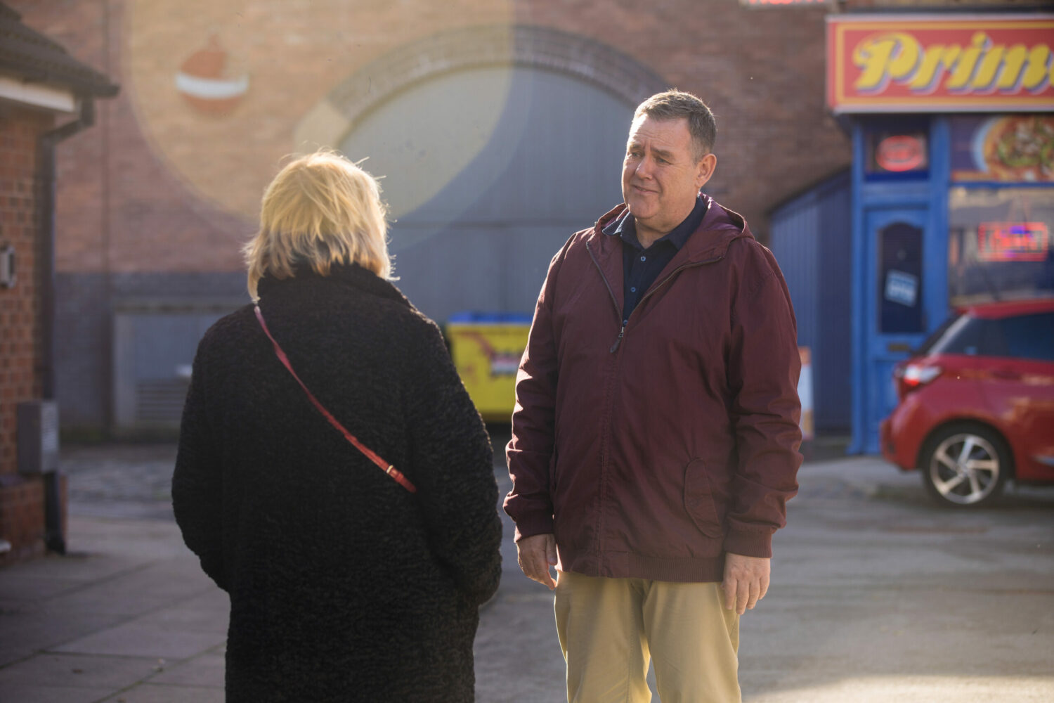 George is speaking to Eileen outside in Corrie