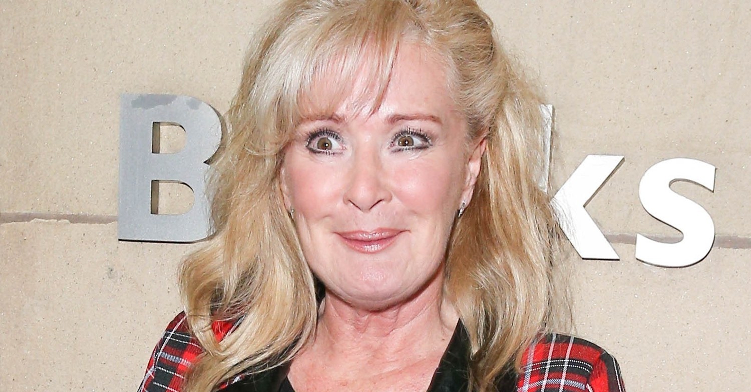 Beverley Callard smiling wearing red