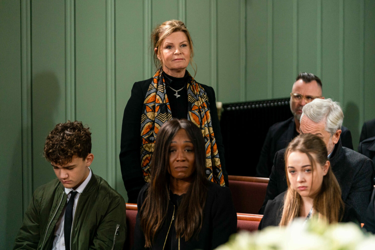EastEnders: Disa stands in the church as Ricky Jnr, Denise and Amy look upset 
