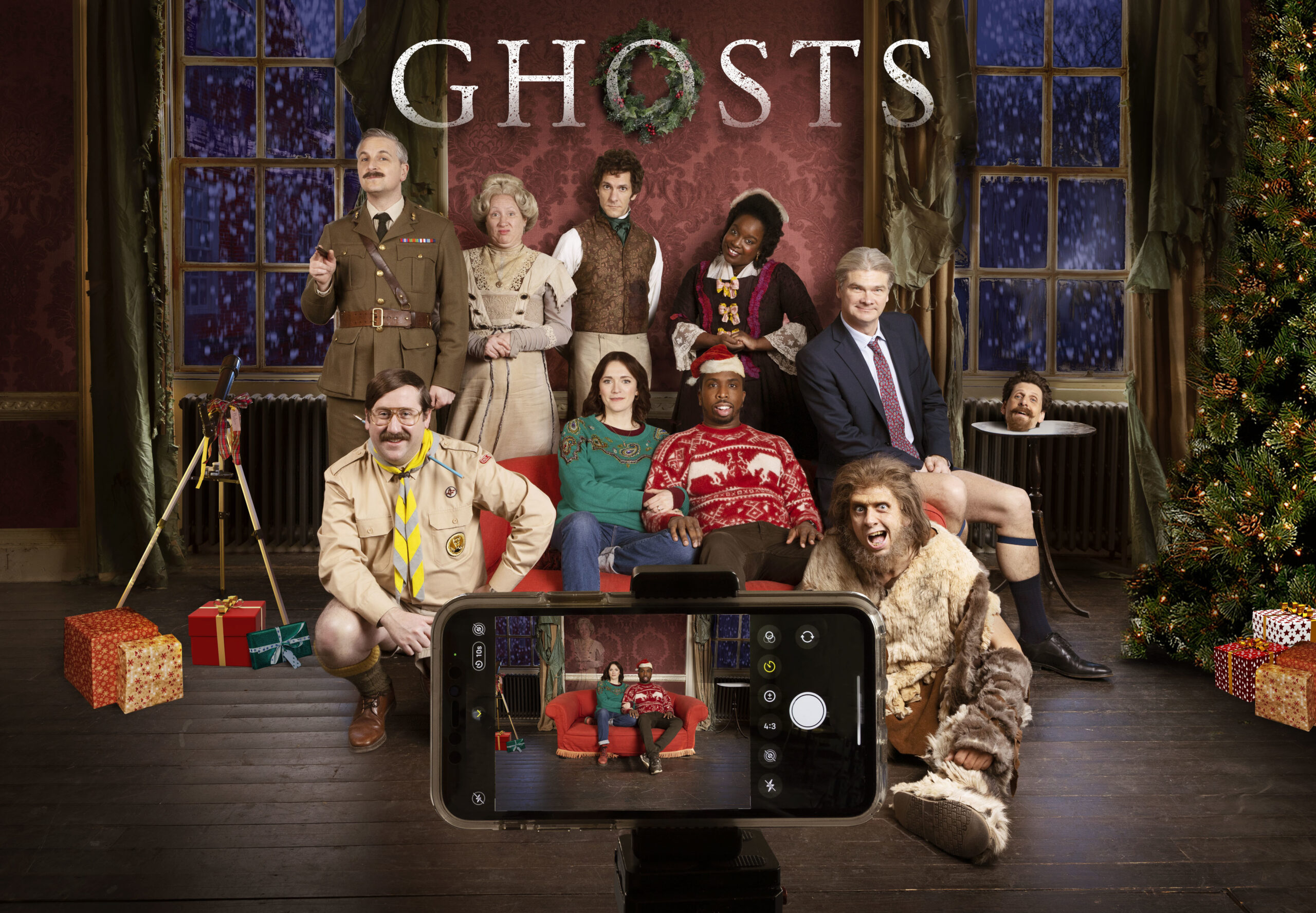 The cast of Ghosts and Pat pose for Christmas Special