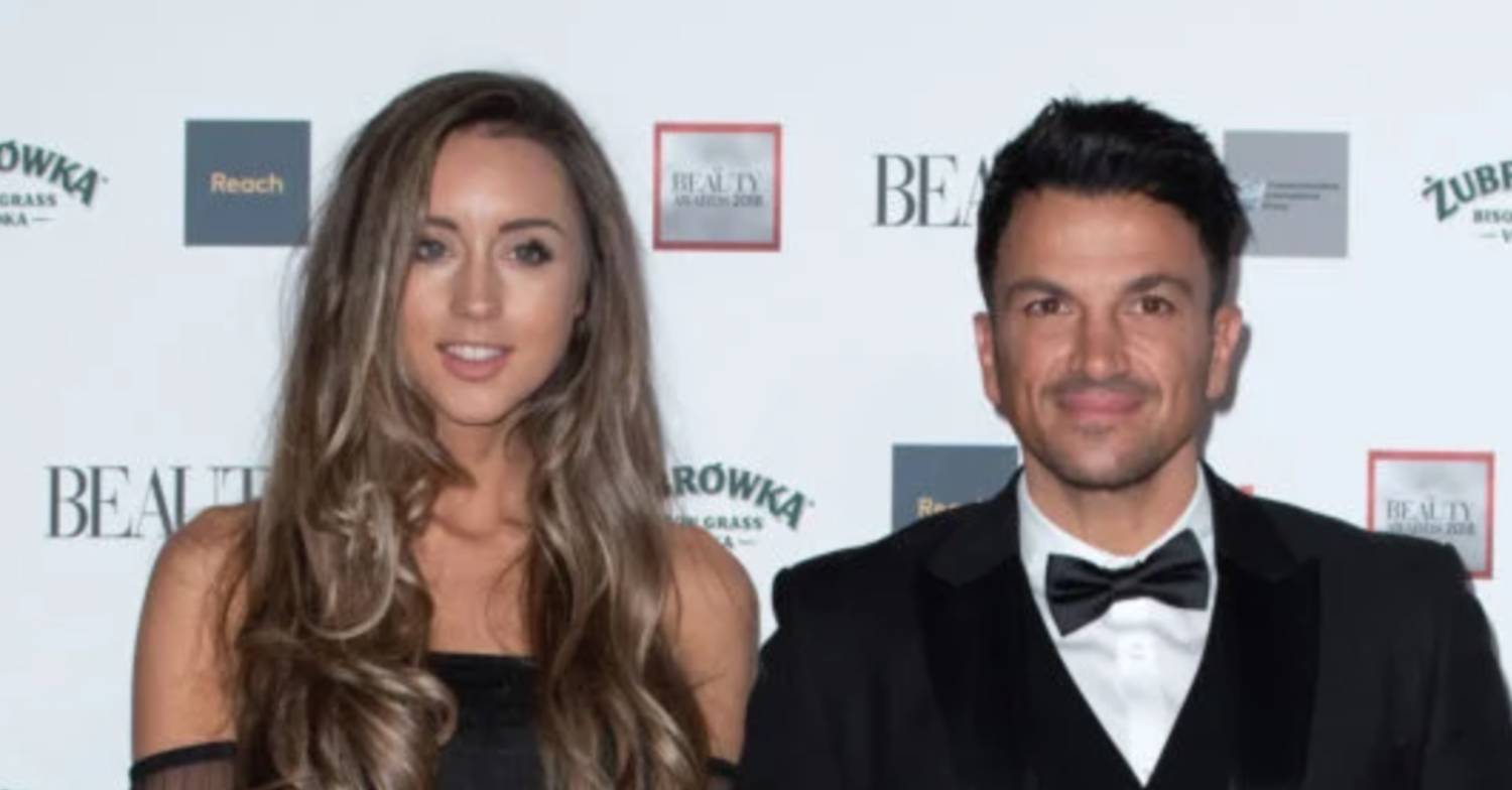 Peter Andre stands next to wife Emily