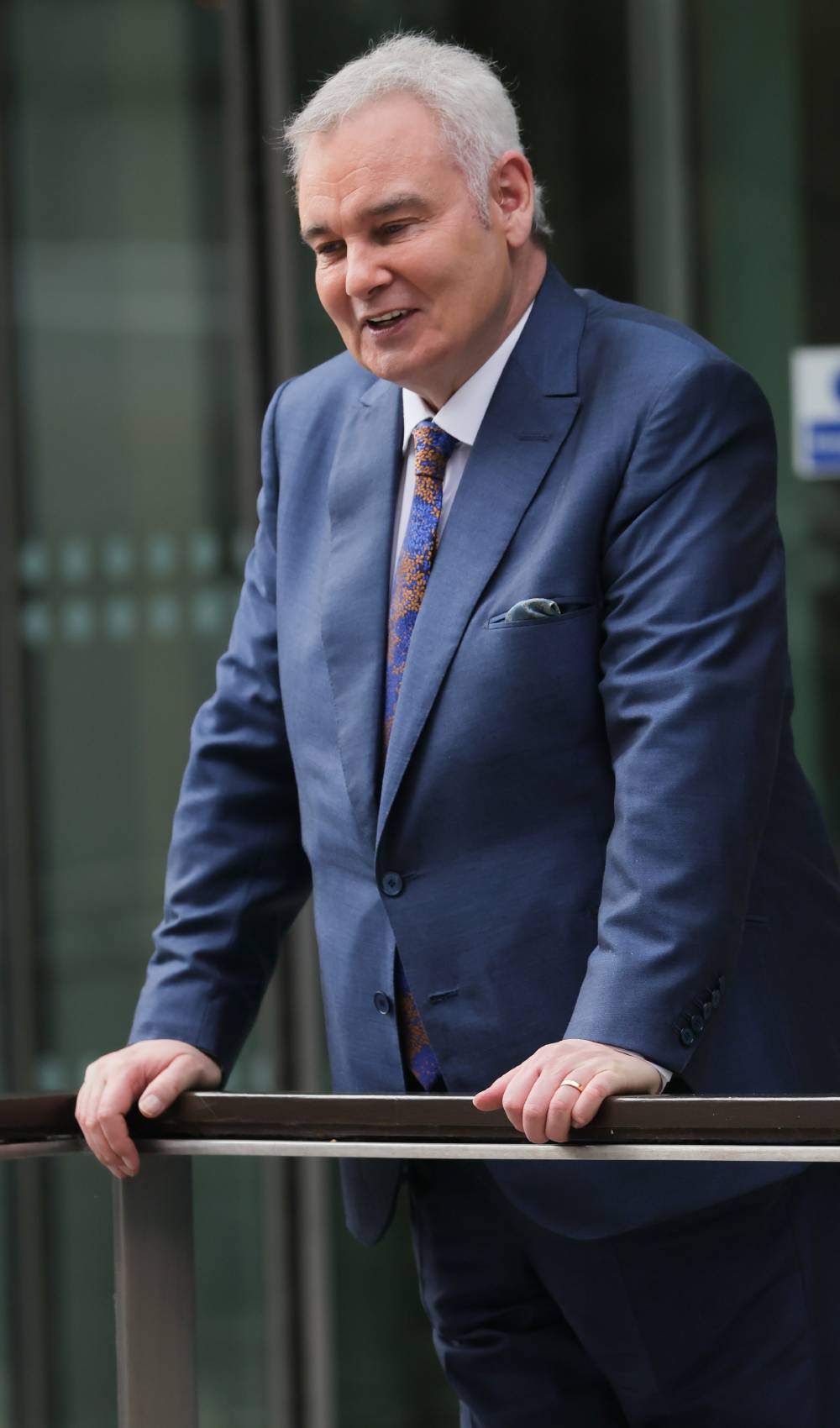 Eamonn Holmes looks downwards as he supports himself