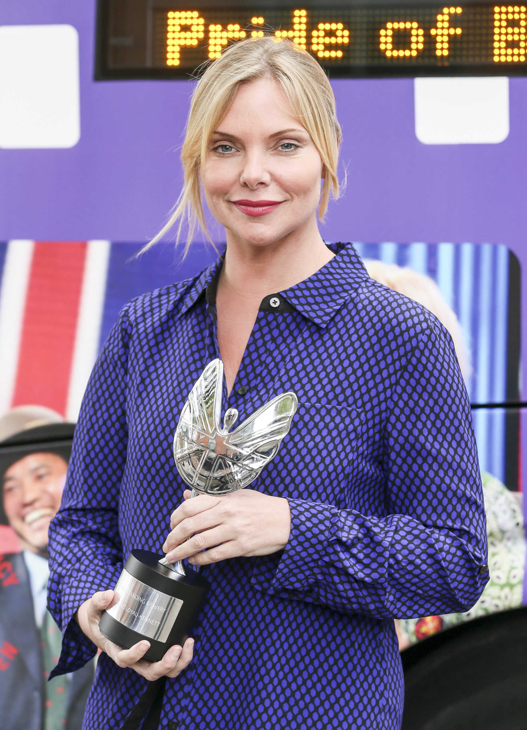 Samantha Womack wearing purple and smiling