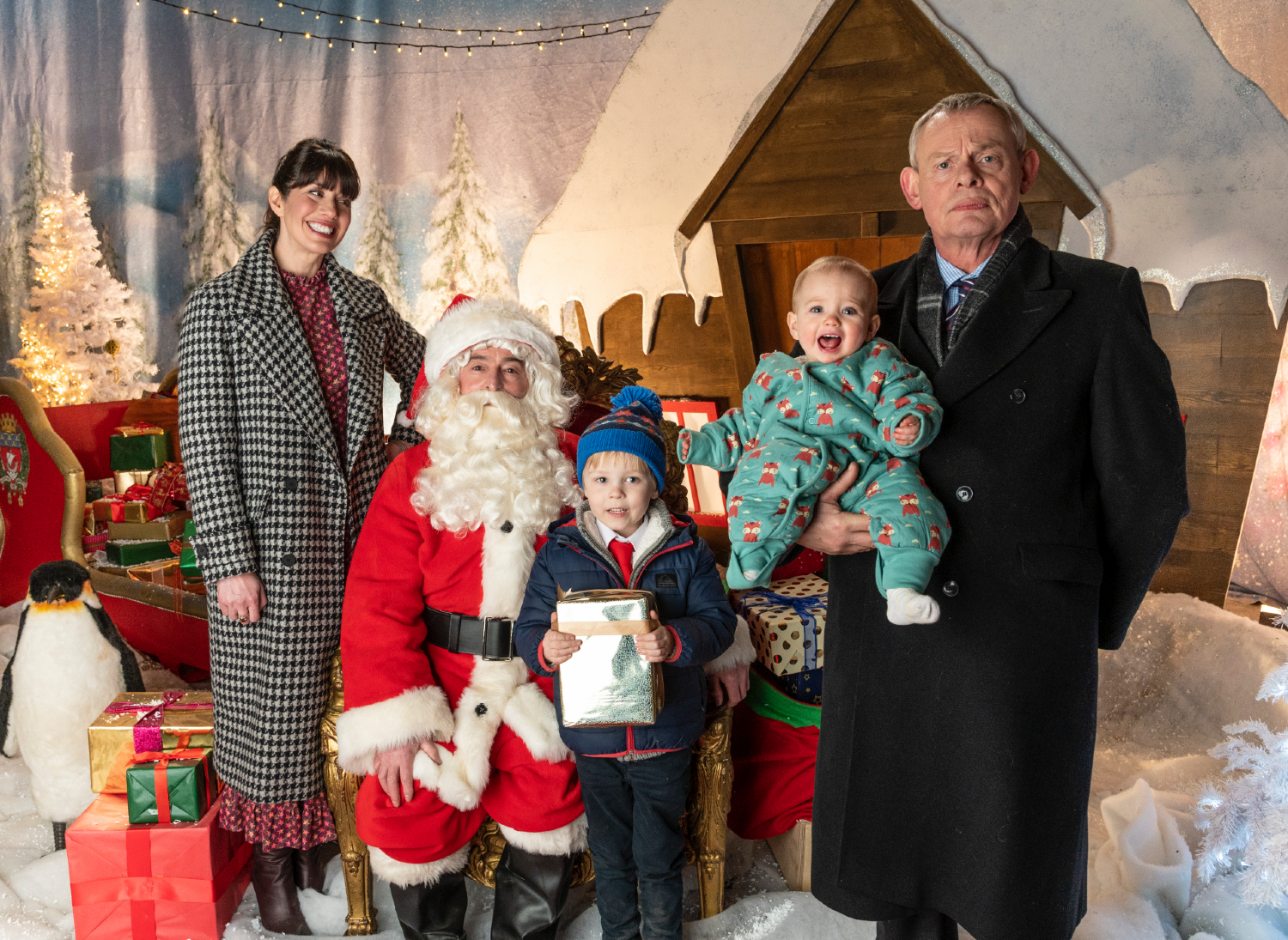 Doc Martin, Louisa, James and Mary standing with Santa