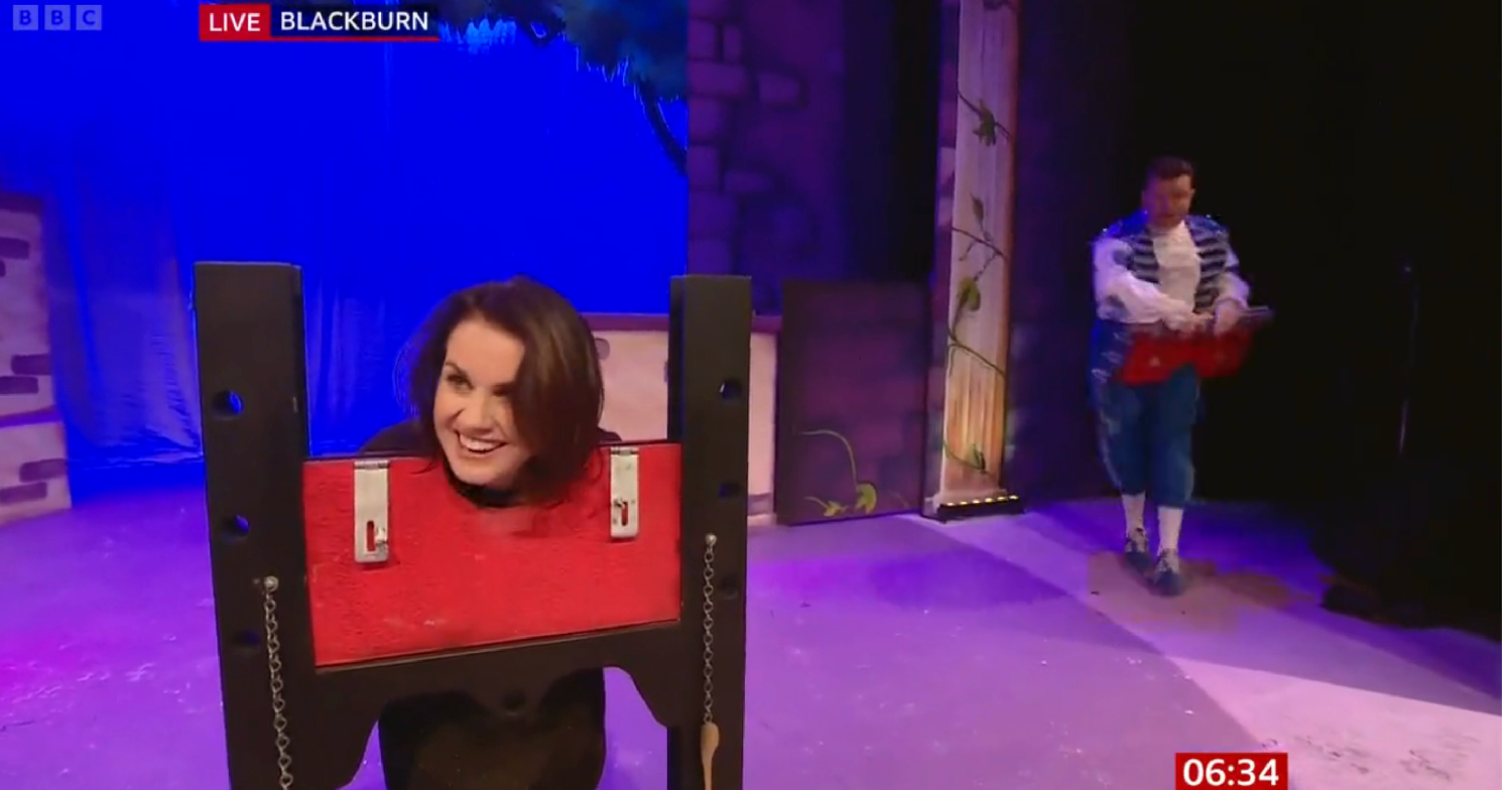 Nina Warhurst with her head in a pantomime guillotine on BBC Breakfast today 