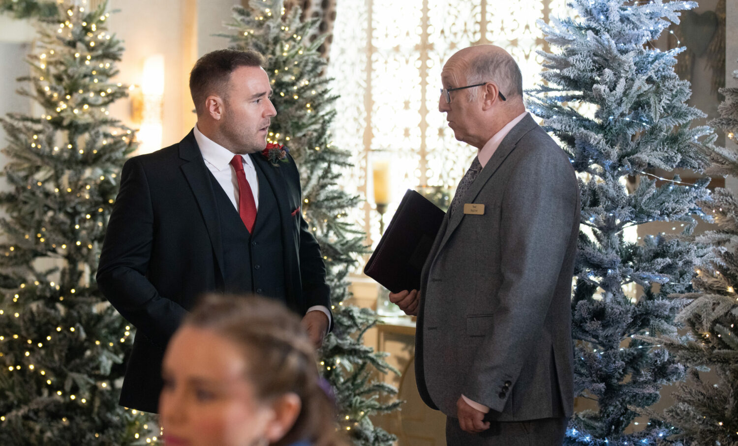 A worried Tyrone talks to the wedding officiate in Corrie