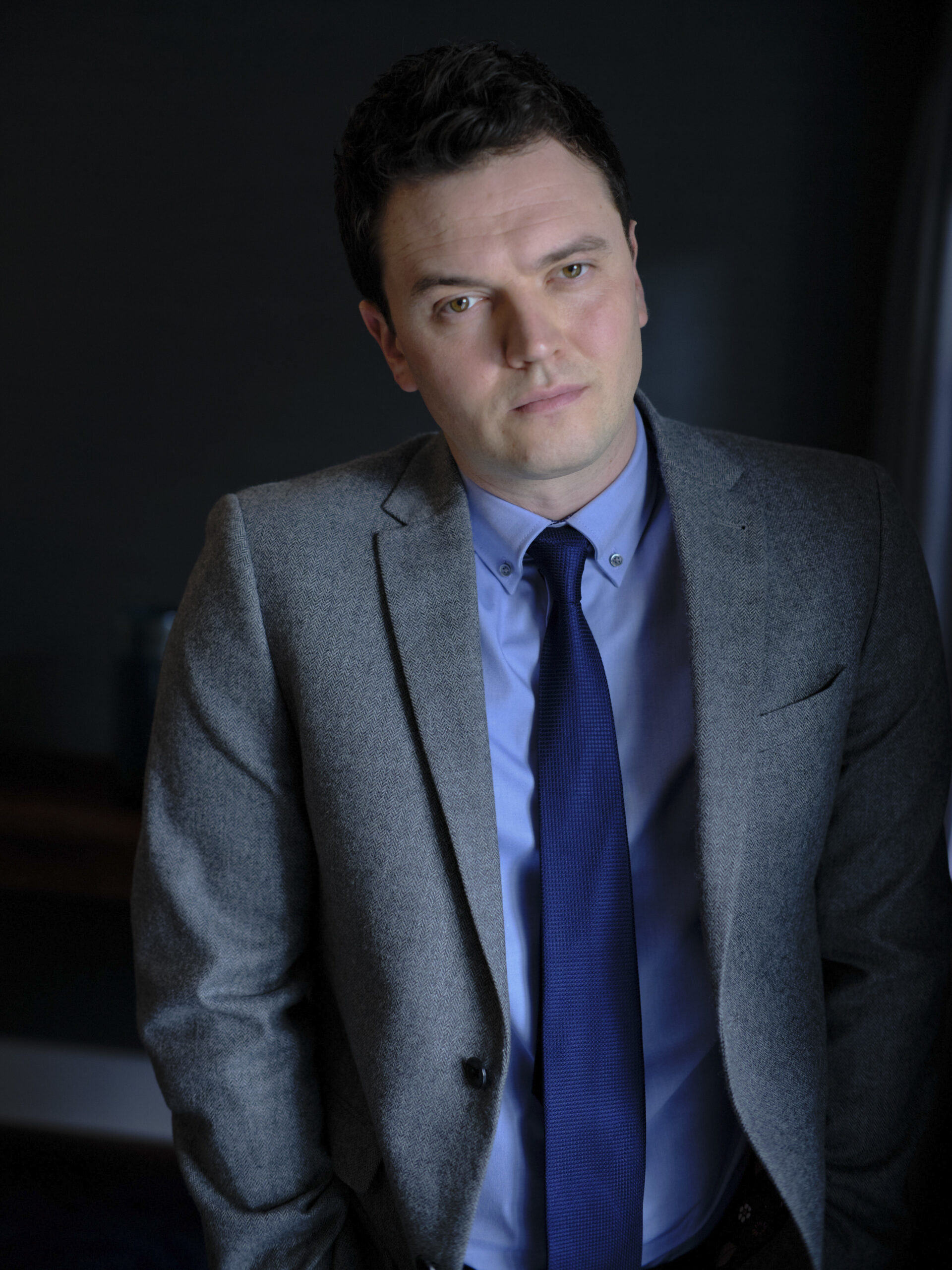 Matthew Cunliffe stands in the office in Strike Troubled Blood