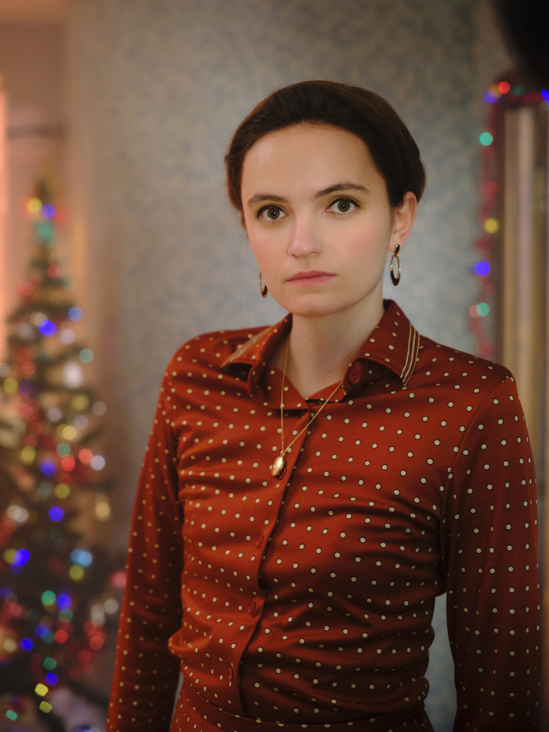 Dr Margot Bamborough stands next to a Christmas Tree