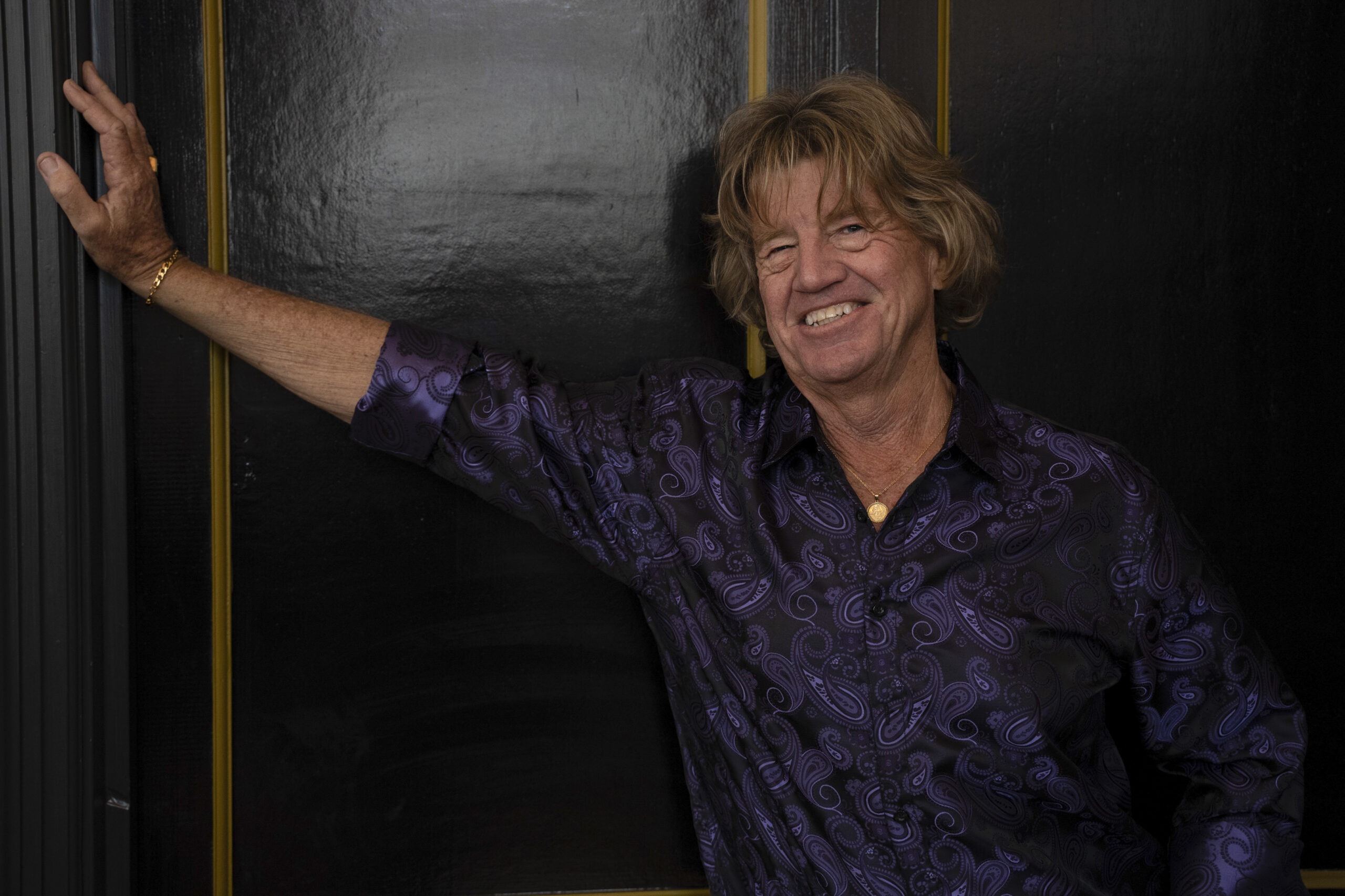 Steve Douthwaite leans against a wall and smiles