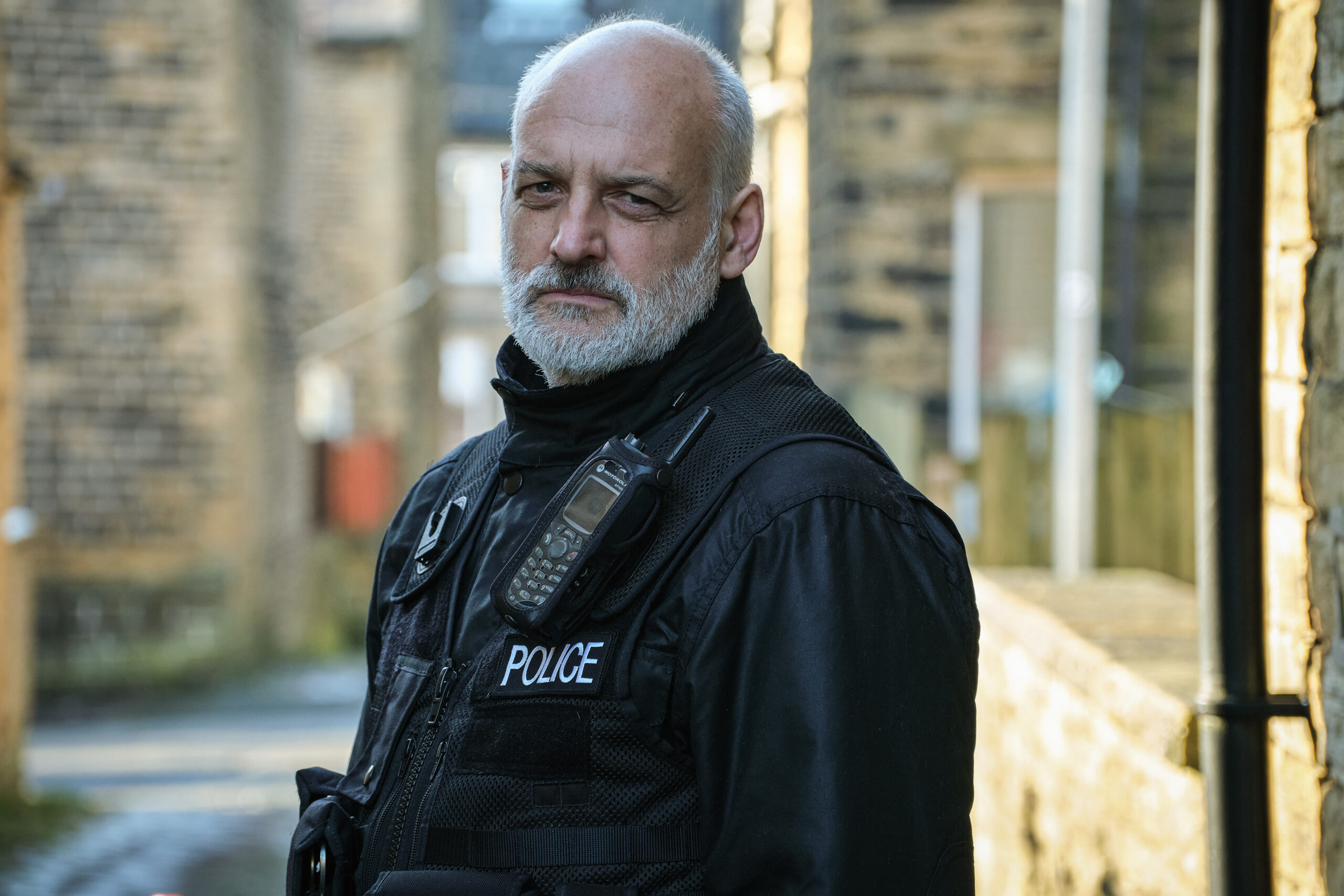 David Prosho wearing a police uniform in Happy Valley