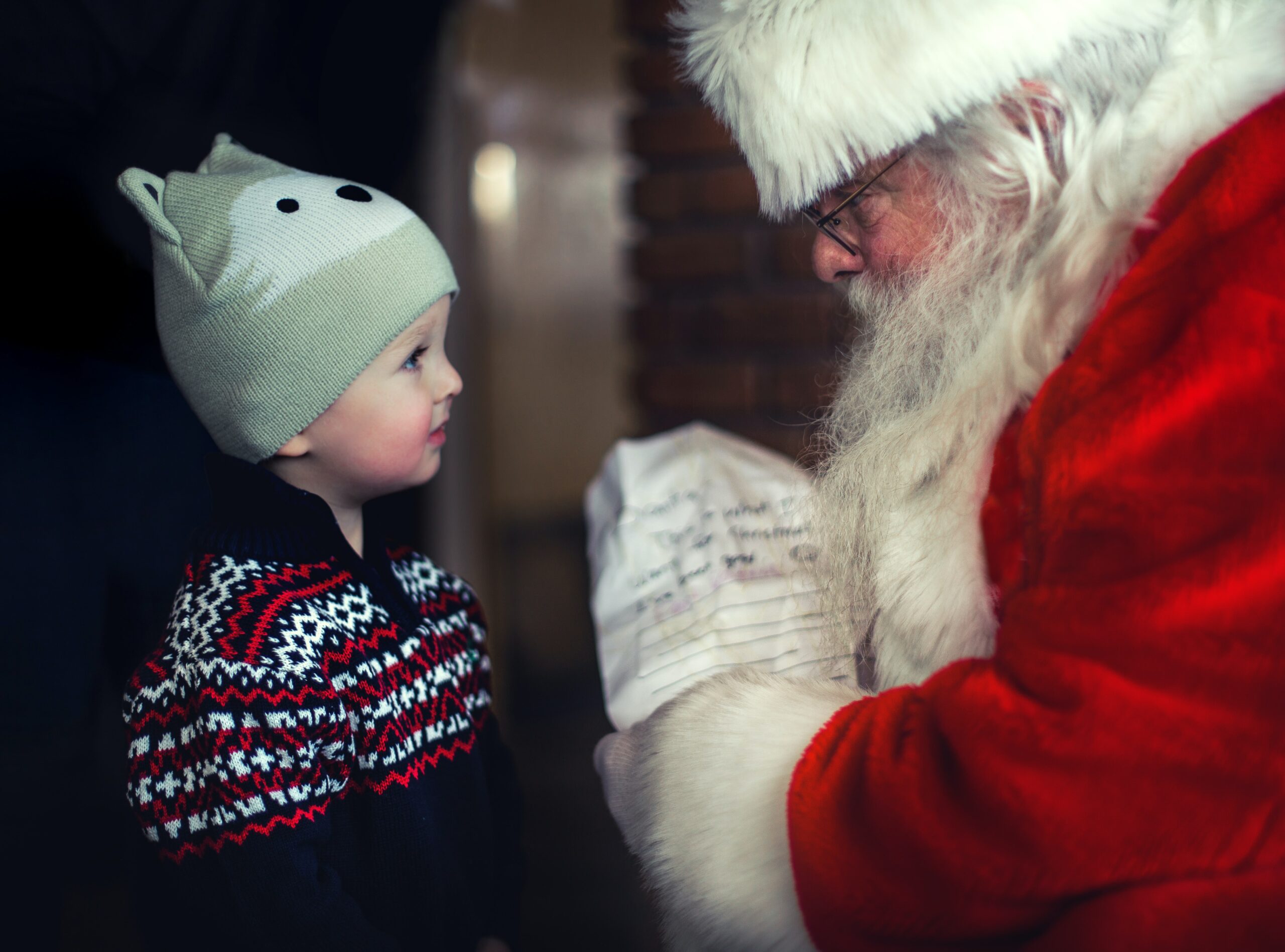Child asking Santa for Christmas gifts