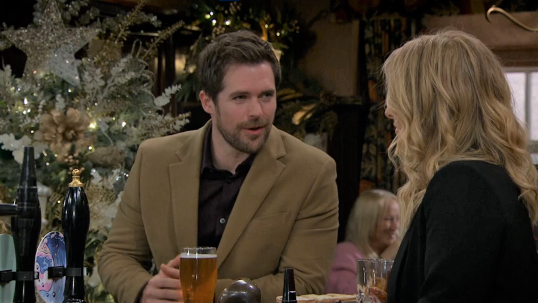 Darren in Emmerdale smiles as he tries to chat up Charity in the Woolpackl