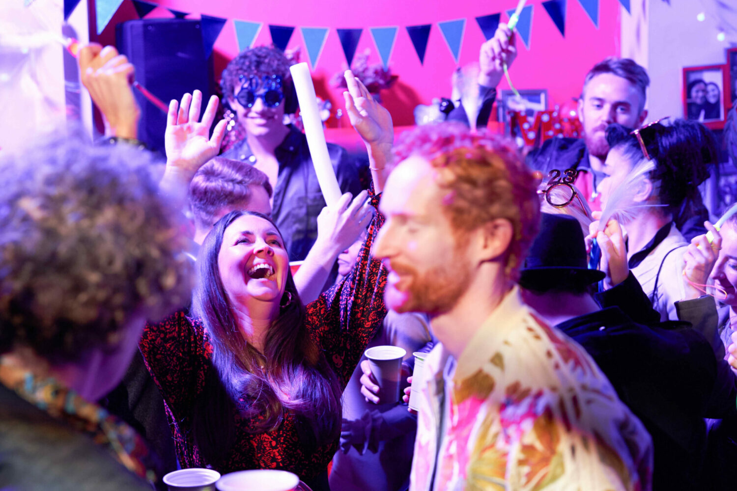 Stacey parties in a crowd of people in EastEnders