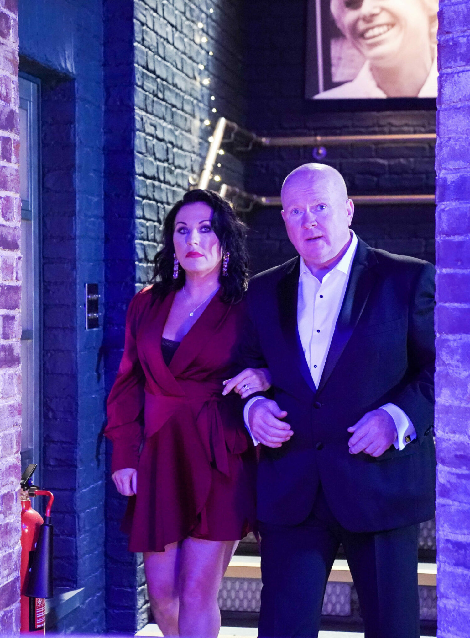 Kat and Phil look serious as they walk into Peggy's