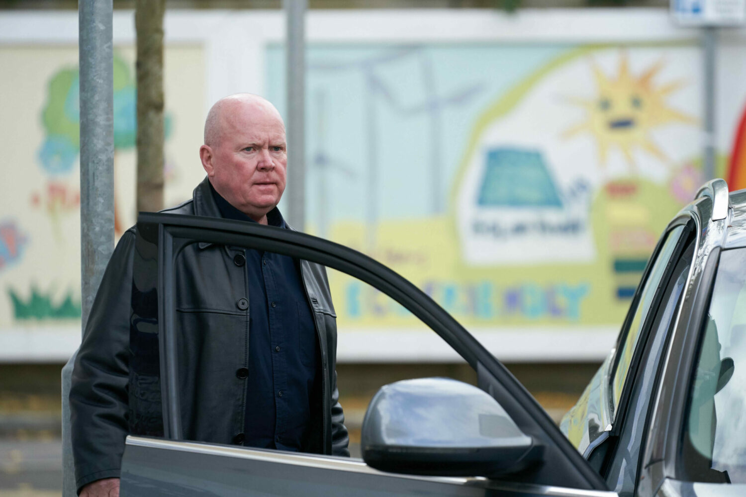 Phil Mitchell looking annoyed as he goes to get in a car in EastEnders
