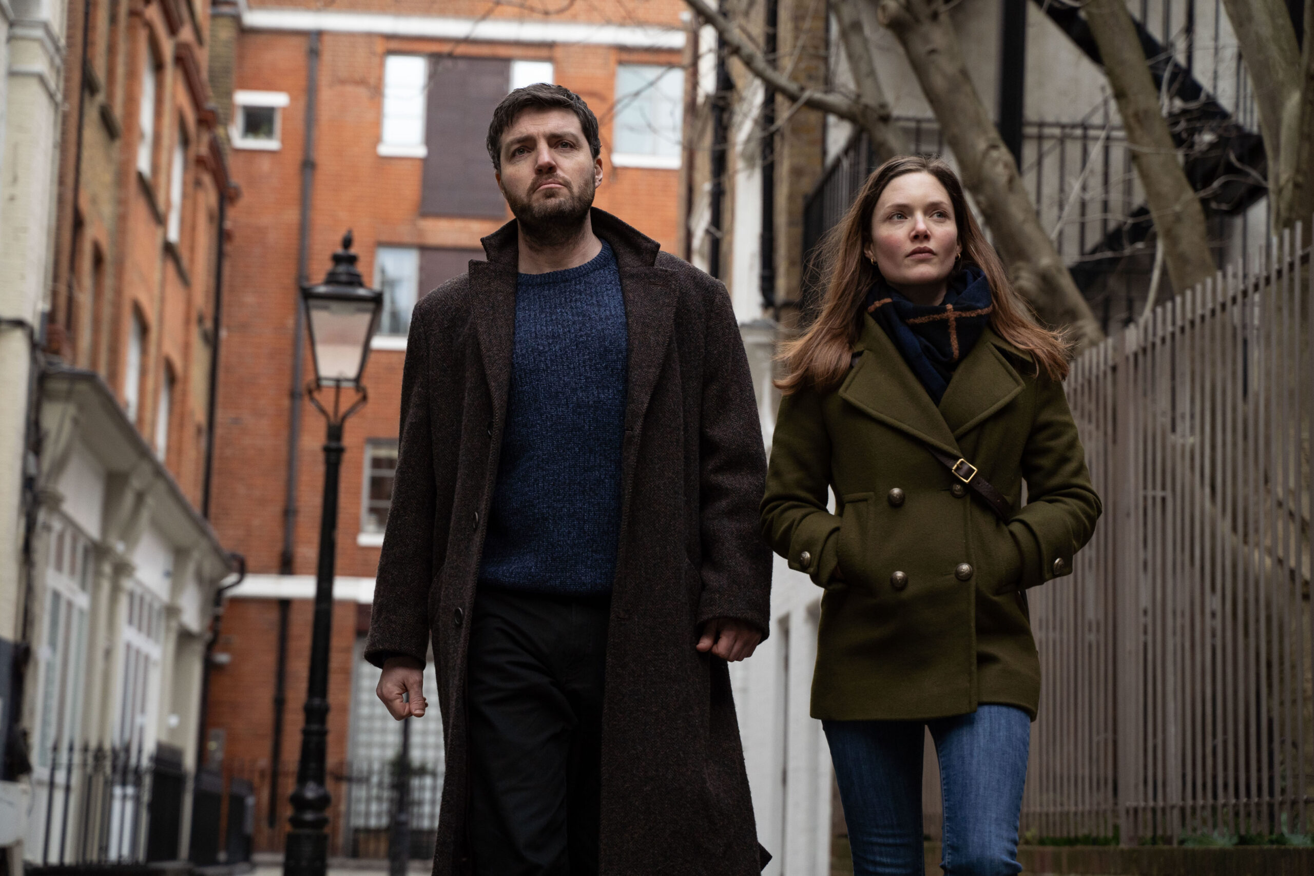 Cormoran and Robin walk down the street in Strike